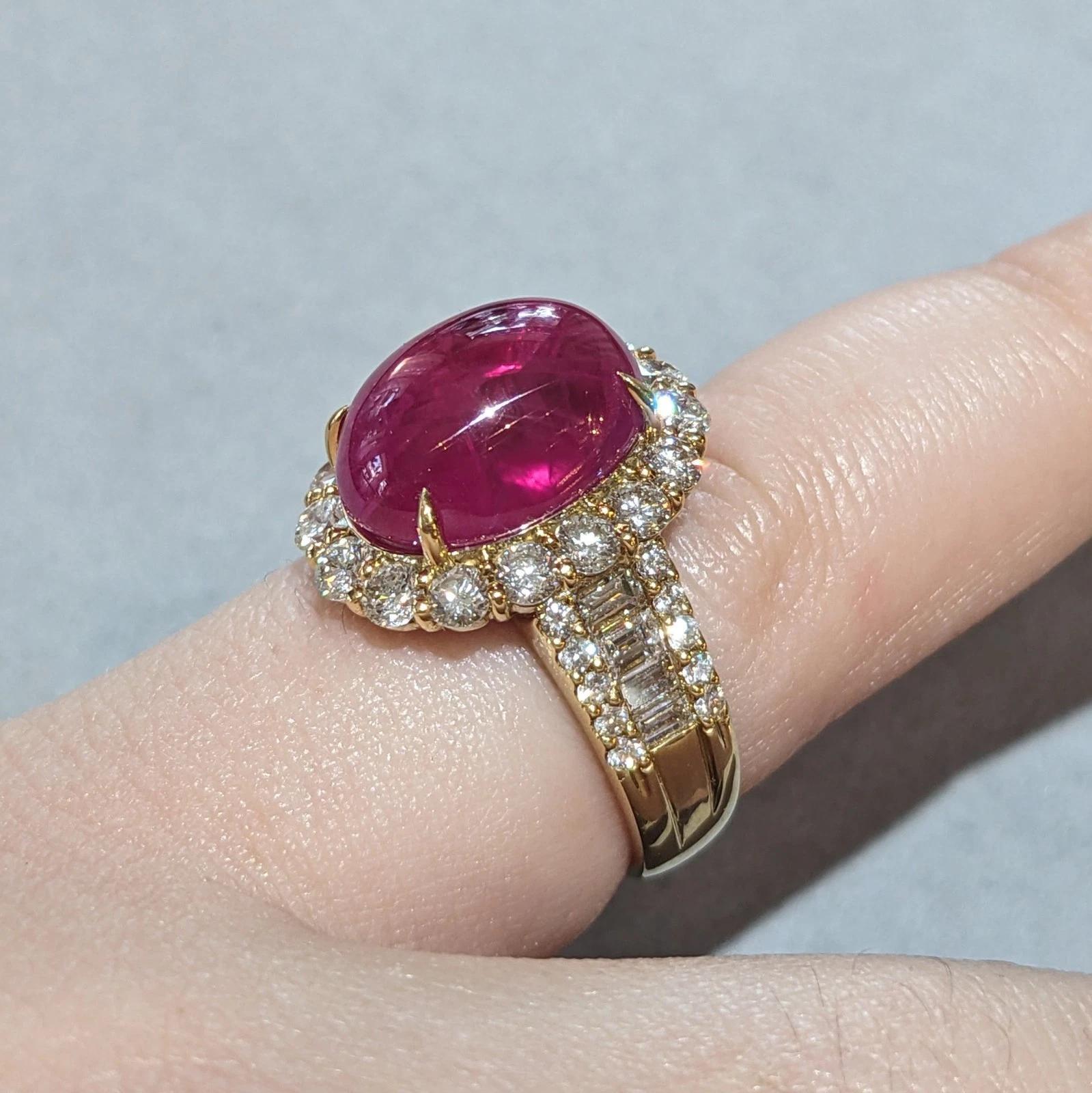 GIA Burma Cabochon Ruby 13.60 ct and Diamond Ring in 18k Yellow Gold

Ruby and Diamond Ring features a GIA certified natural Burma Ruby Cabochon weighing 13.60 carats with a halo of Round Diamonds and Round and Baguette Diamonds on the sides, all