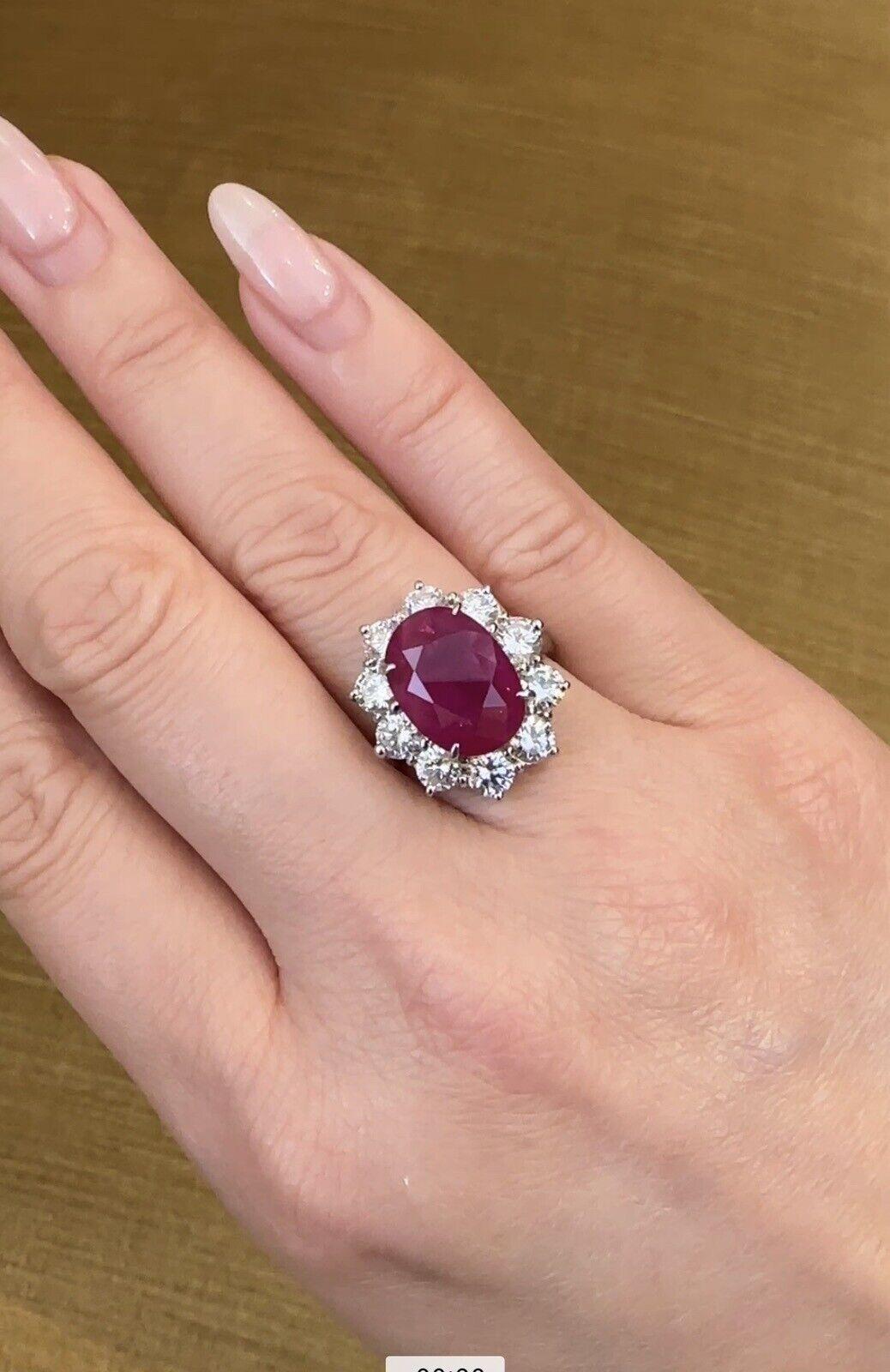 GIA Burma Heated Ruby 7.71 Carat Oval in Diamond Platinum Ring

Ruby and Diamond Ring features a large purplish-red Oval Ruby surrounded by 10 Round Brilliant Diamonds set in Platinum. The ruby originates from Burma(Myanmar) and has been heat