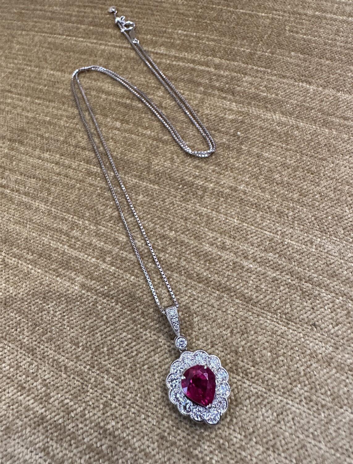GIA Burma Ruby Pear-Shaped Pendant with Diamonds in Platinum

Ruby and Diamond Pendant Necklace features a 2.02 carat Pear-shaped Red Ruby surrounded by 12 Natural Round Brilliant Diamonds, with Round Diamonds in the bale, all set in Platinum on a