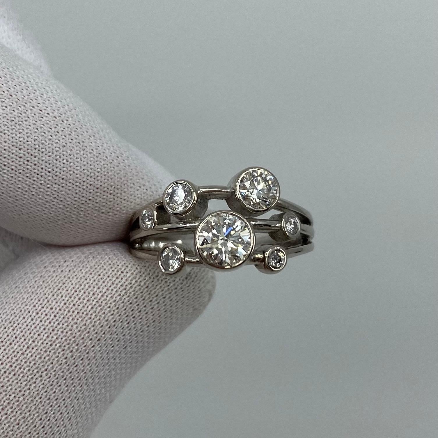 1.00 Carat Diamond Raindance-Style 18k White Gold Ring.

A beautiful 18 Karat white gold ring set with 7 round brilliant cut white diamonds. 
The largest diamond is a GIA Certified 0.70ct with Si2 clarity and H colour, also has a very good round