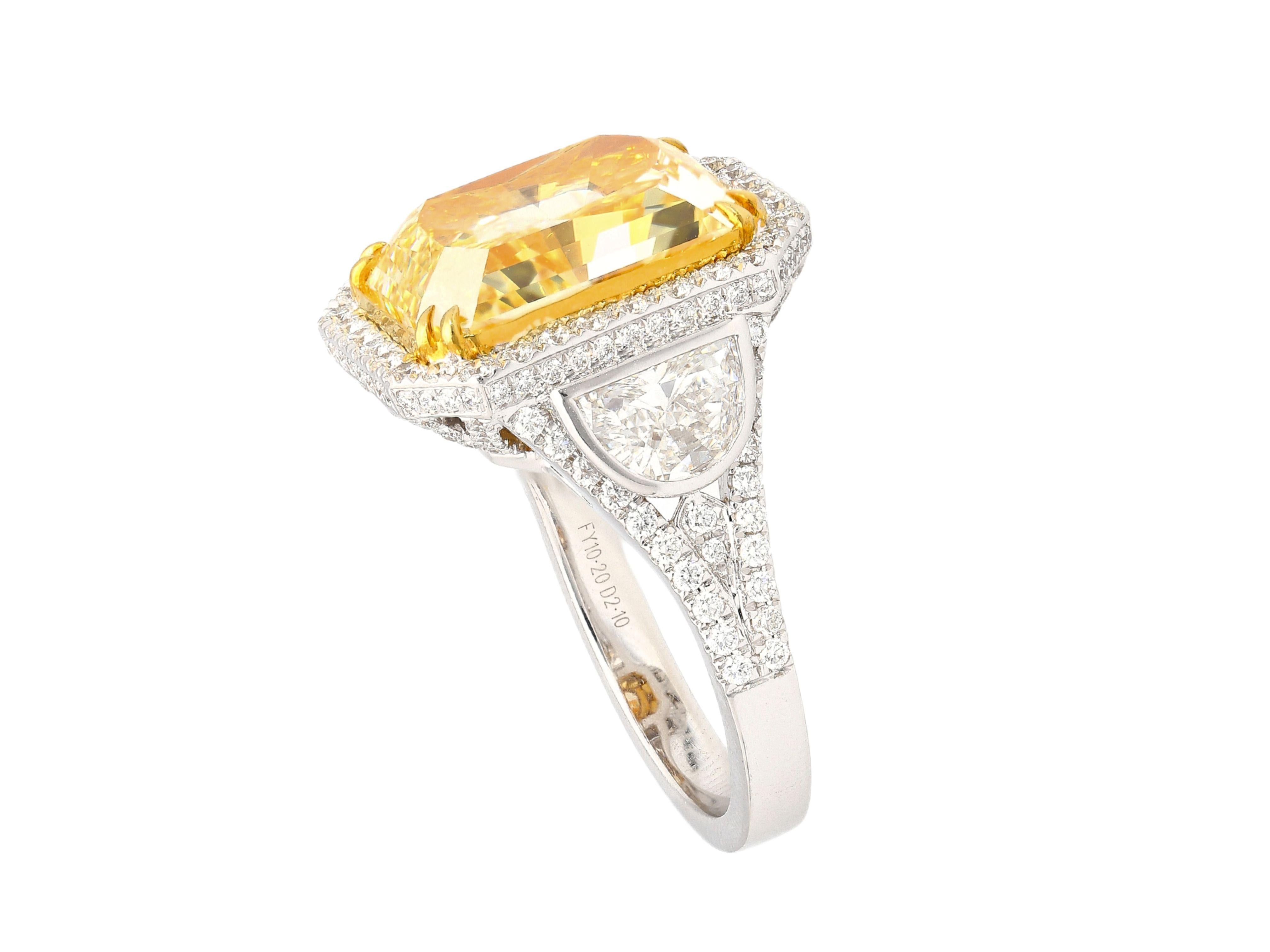 GIA certified 10.20 carat fancy intense yellow radiant cut diamond engagement ring. Set in 18k white and yellow gold. The ring features a dazzling round cut white diamond halo and encrusted ring shank, yellow gold prongs, and an open back on the