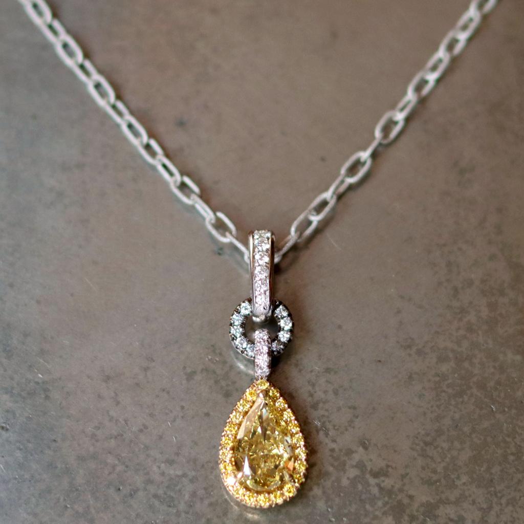 This stunning Charm pendant is handmade in Belgium the traditional way, by jewelry artist Joke Quick,  ( no casting or printing envolved) in 18ct yellow & white gold and is hand set with a GIA Certified 1.50 carat Fancy Deep Brownish Yellow Pear