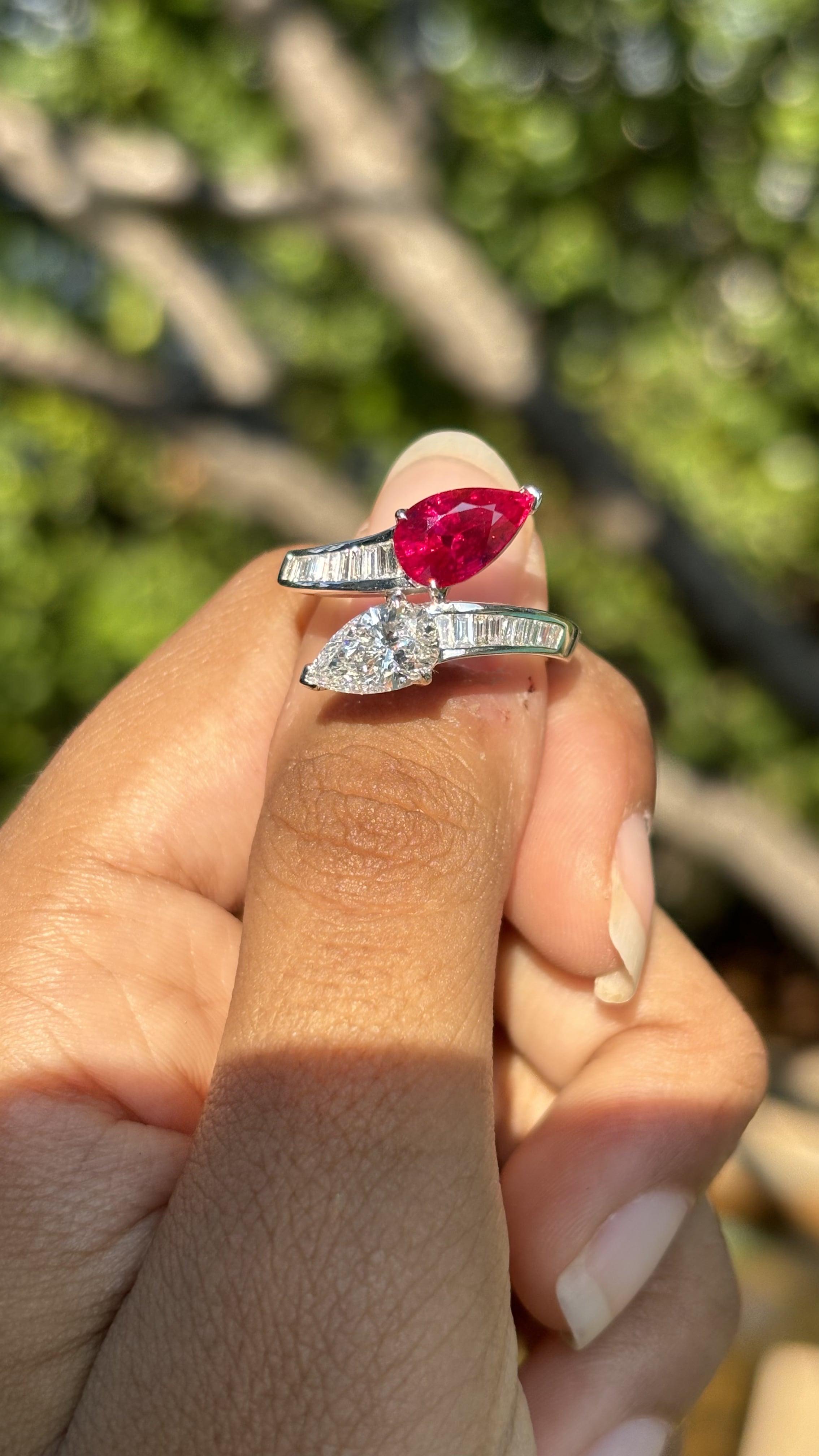 Introducing our exquisite Toi Et Moi Ring, a masterfully crafted symbol of timeless elegance and sophistication. This captivating piece features a stunning 2.07 Carat pear-shaped Burma, renowned for its rich, pigeon blood hue and exceptional luster.