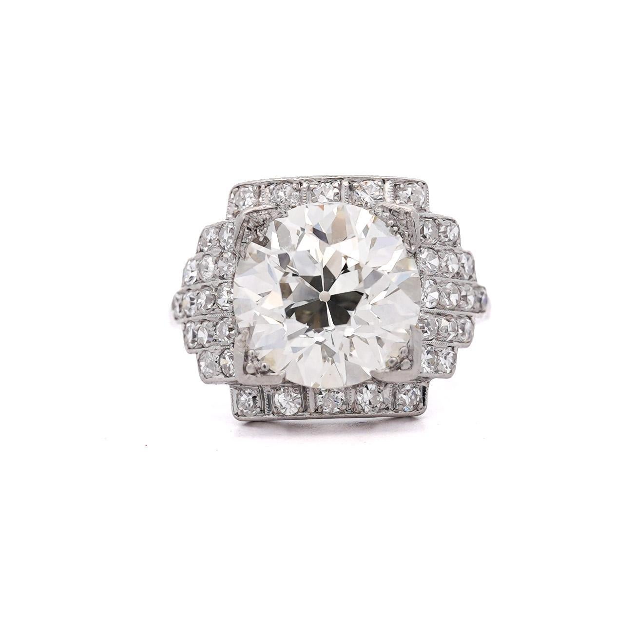 An antique Edwardian-era platinum engagement ring featuring a stunning GIA certified 5.01-carat old European cut diamond surrounded by a dazzling halo of 38 old-cut cascading diamonds.

Details:
Item Type: Engagement Ring
Metal: Platinum (PT)
Ring