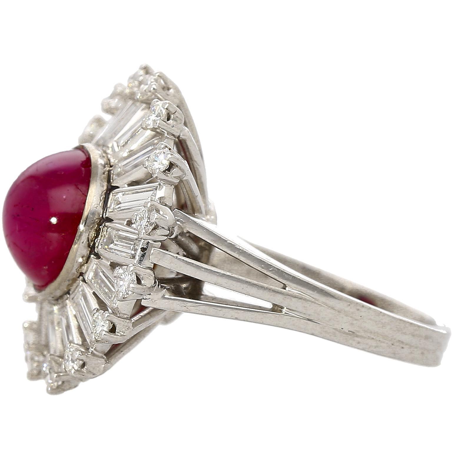 This vintage Art Deco Ballerina design ring sets a GIA certified 7.40 carat purplish red star ruby and is framed with 1.75 carat of baguette and round cut diamonds. This bold cocktail ring is set in 18K white gold with a dramatic ballerina style