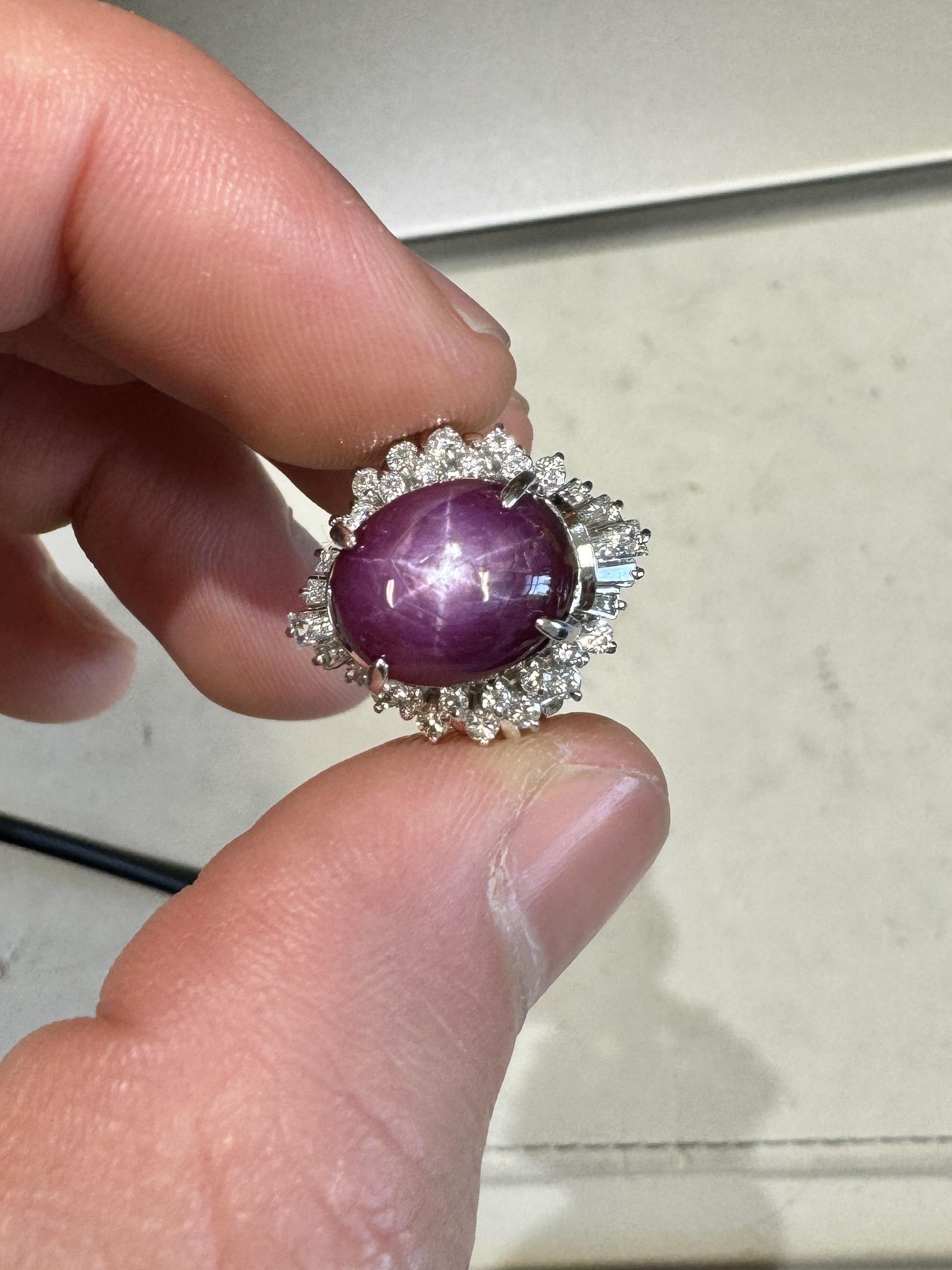 GIA Certified unheated 9.72-carat purplish red star ruby sits at the heart of this vintage mixed cut diamond platinum ballerina-style ring.

Details:
Item Type: Cocktail Ring
Metal: Platinum (PT900)
Size: 6 1/4 (adjustable)
Weight: 9.72