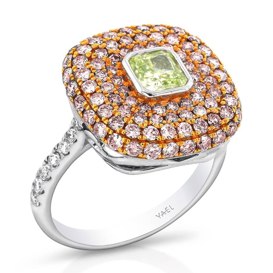 A square-shaped fancy intense yellowish green diamond with clipped-corners is set within a contrasting cushion of pavé-set pink diamonds set in rose gold. A shank of white gold set with white diamonds further contrast and emphasis the charming