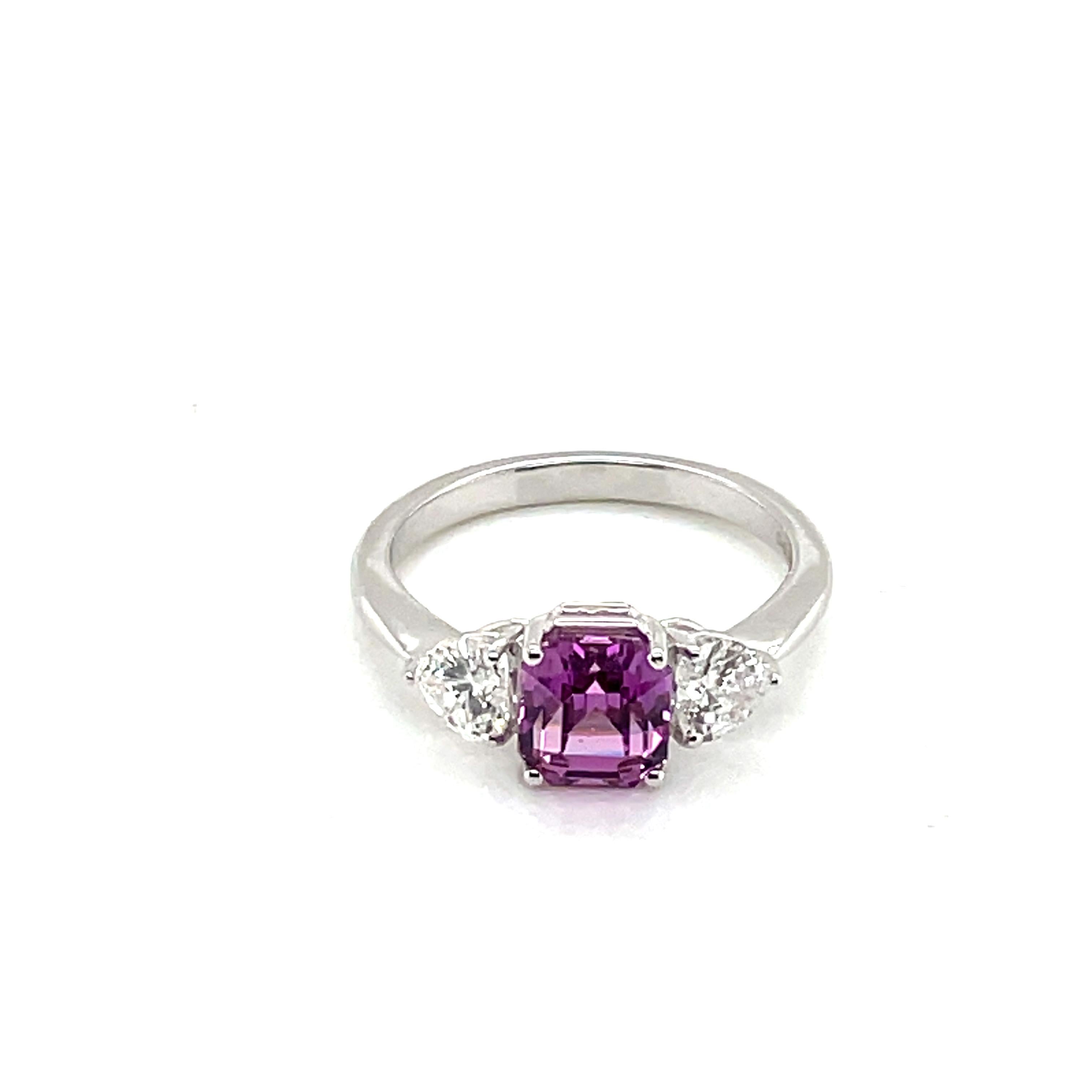 At its center, a captivating octagon-shaped purplish pink sapphire (2.26 cts), sourced from Madagascar and noted for its no-heat treatment.

Flanked by two diamond hearts (0.77 cts) and set in radiant 18k white gold (3.08 grams), this engagement