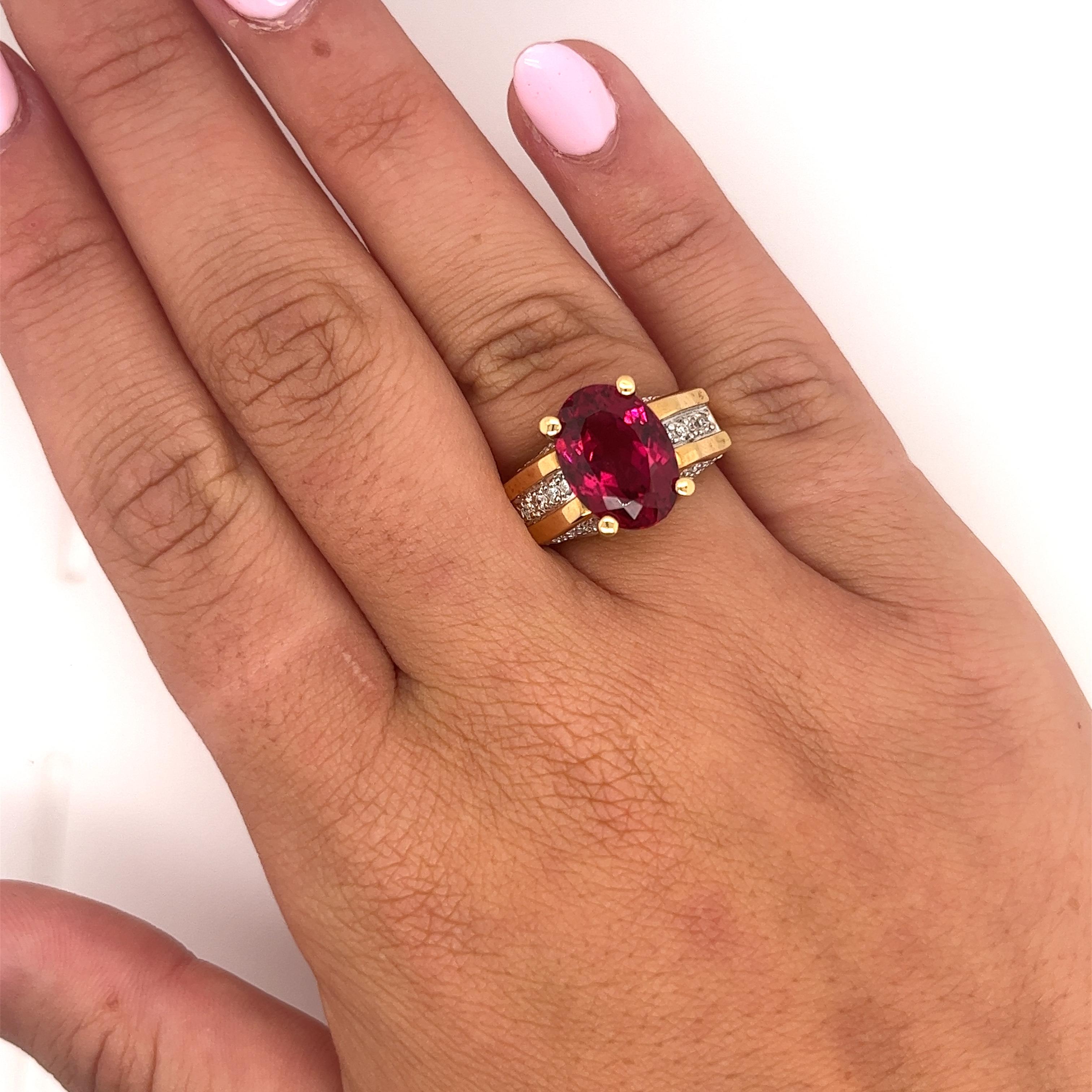 GIA Certified Oval Brilliant 7 Carat Purplish Red Tourmaline Ring, set in 18K Two Tone Gold. Adorned with 26 Round Cut Diamond Side Stones, Totaling 1.35 carats.

The center stone has a rich deep color saturation and minimal/none inclusions to the