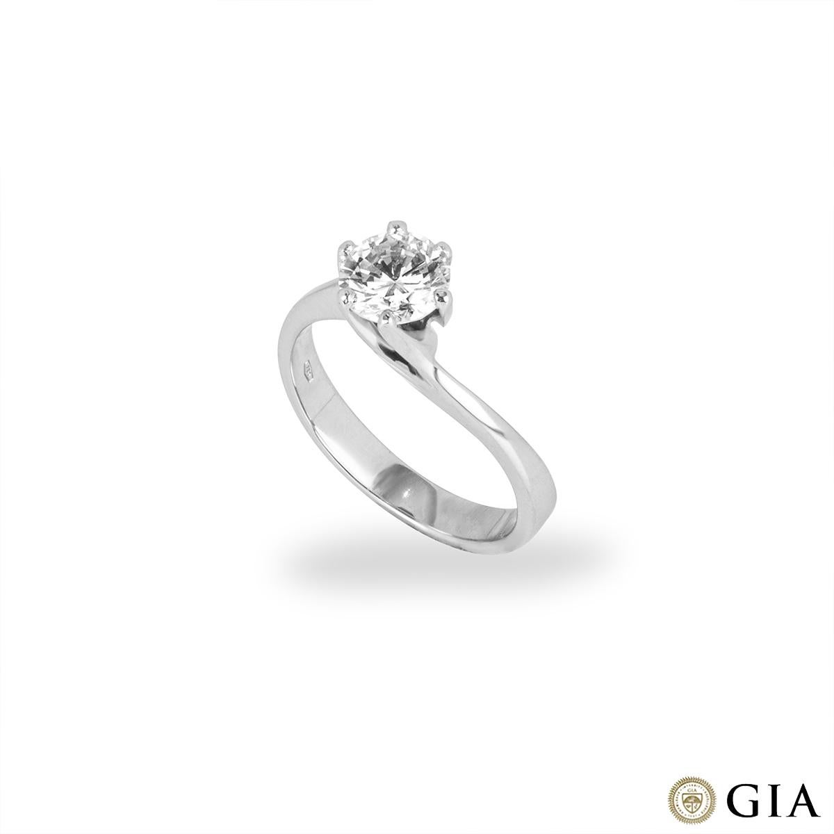 An elegant 18k white gold diamond engagement ring. The solitaire comprises of a twisted central 6 claw mount set with a round brilliant cut diamond weighing 1.07ct, J colour and SI1 clarity. The ring is currently a UK size N/ US size 6 1/2 but can