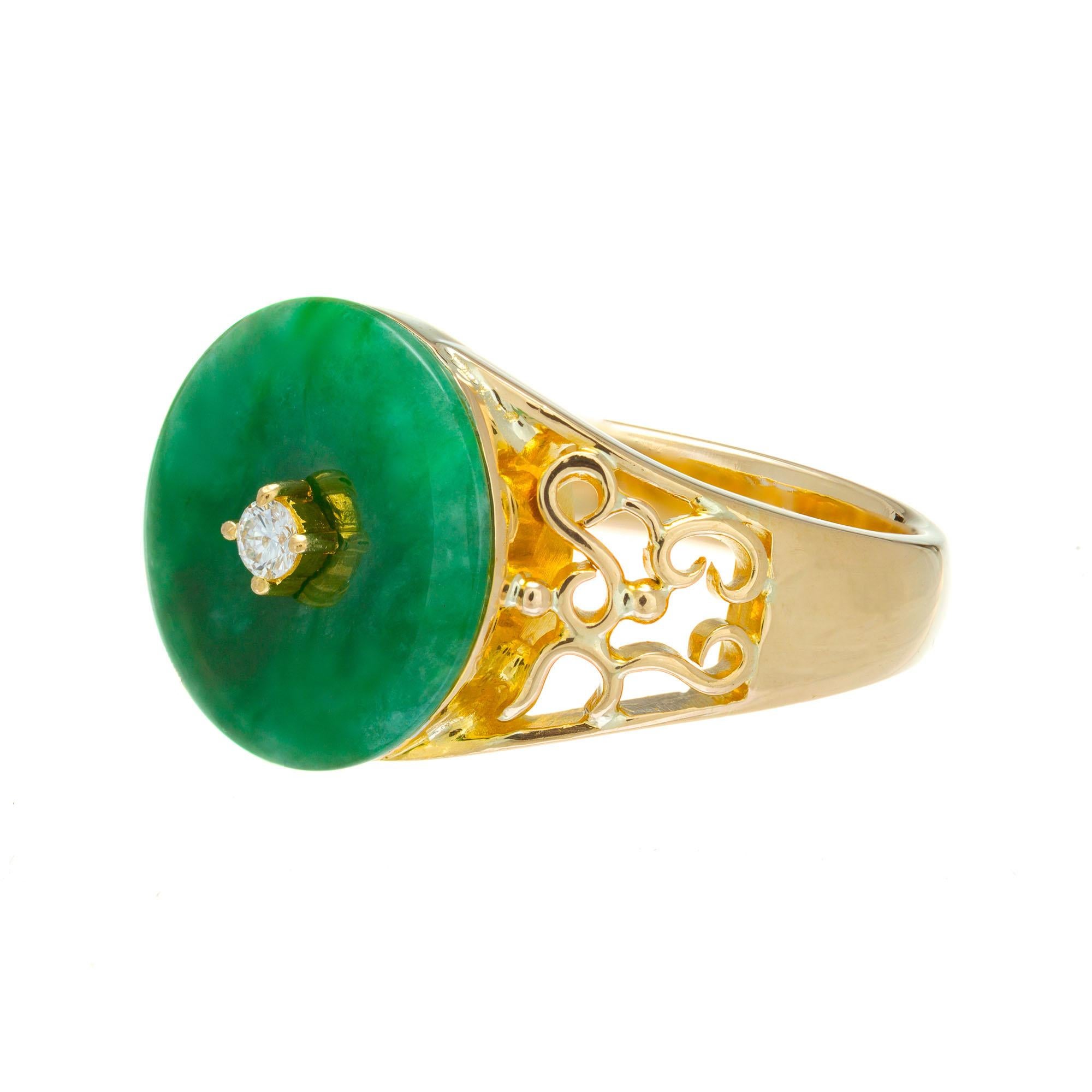 GIA Certified Jadeite Jade translucent mottled green pierced disc ring in 20k yellow gold with a round diamond center.

1 round disc pierced mottled green jadeite jade 13.34mm GIA Certificate # 2201372867
1 round brilliant cut diamond H VS2, approx.