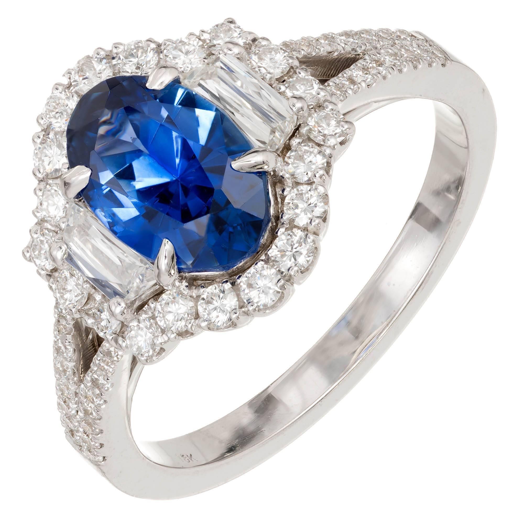 Natural vivid cornflower blue 1.82 ct GIA certified Sapphire and diamond halo engagement ring. The setting was designed and made in the Peter Suchy Workshop to show of the center stone with a halo of full cut diamonds and two trapezoid side