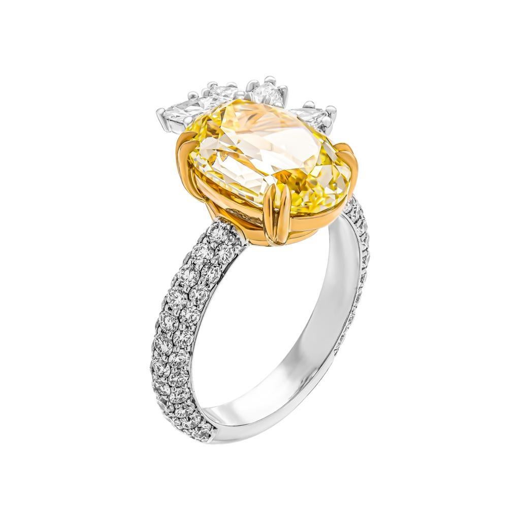 One GIA Certificated 5.07ct custom made Fancy Yellow / Vs2 oval natural diamond set in a platinum and 18kt ring with marquise and pearshape cut white diamonds, 1 x Marquise Cut diamond 0.19ct, 3 x Pearshape diamonds 0.33cts, 68 Round Brilliant Cut