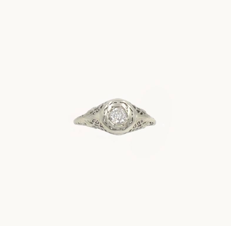 An Old European Cut diamond and 18 karat white gold vintage engagement ring from circa 1930s.  This ring features a 0.28 carat Old European Cut diamond that is E in color and VVS1 in clarity (via GIA certificate) set flush with the surrounding gold