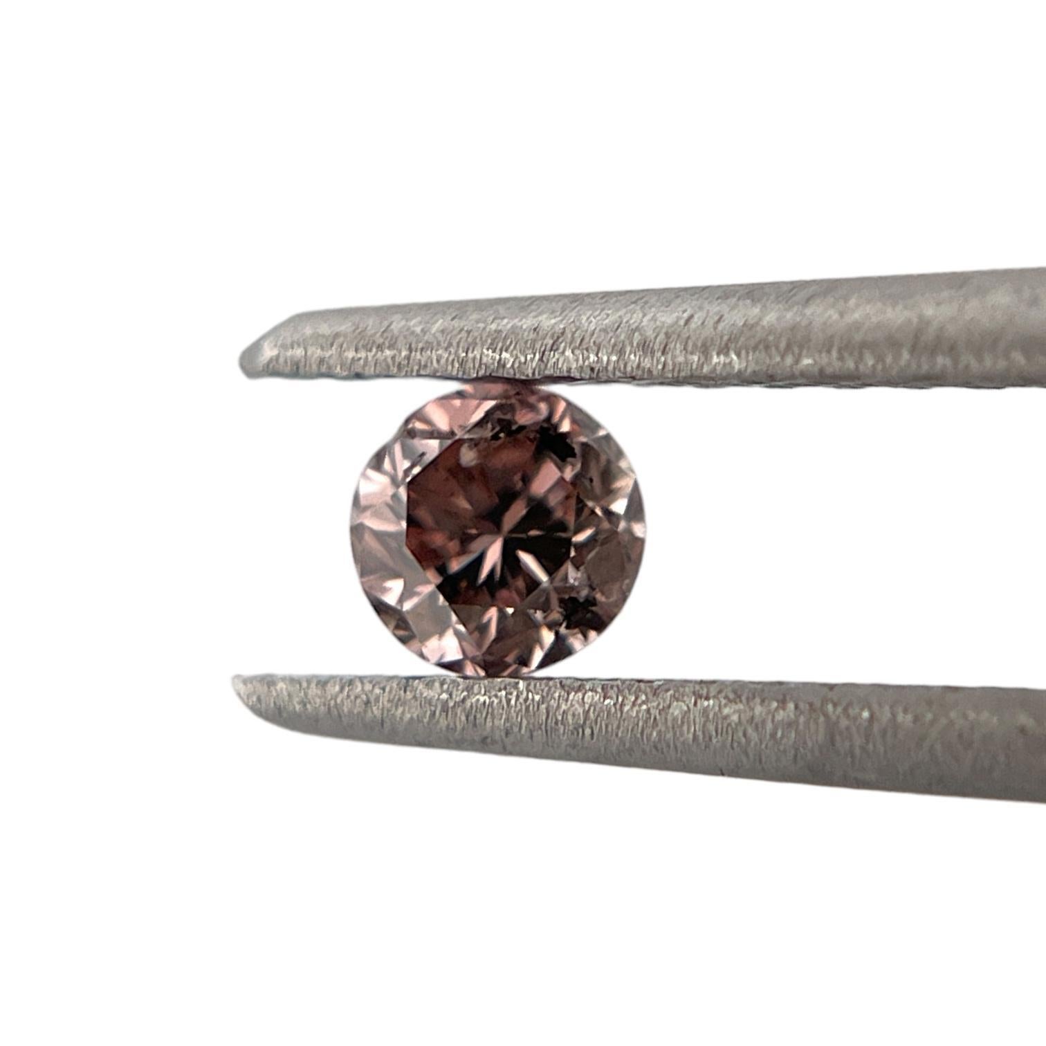 ITEM DESCRIPTION

ID #: NYC57744
Stone Shape: Round
Diamond Weight: 0.28 Carat
Fancy Color: Brownish Pink
Cut:	Brilliant
Measurements: 4.32 x 4.36 x 2.48 mm
Symmetry: Excellent
Polish: Excellent
Fluorescence: None
Certifying Lab: GIA
GIA Certificate