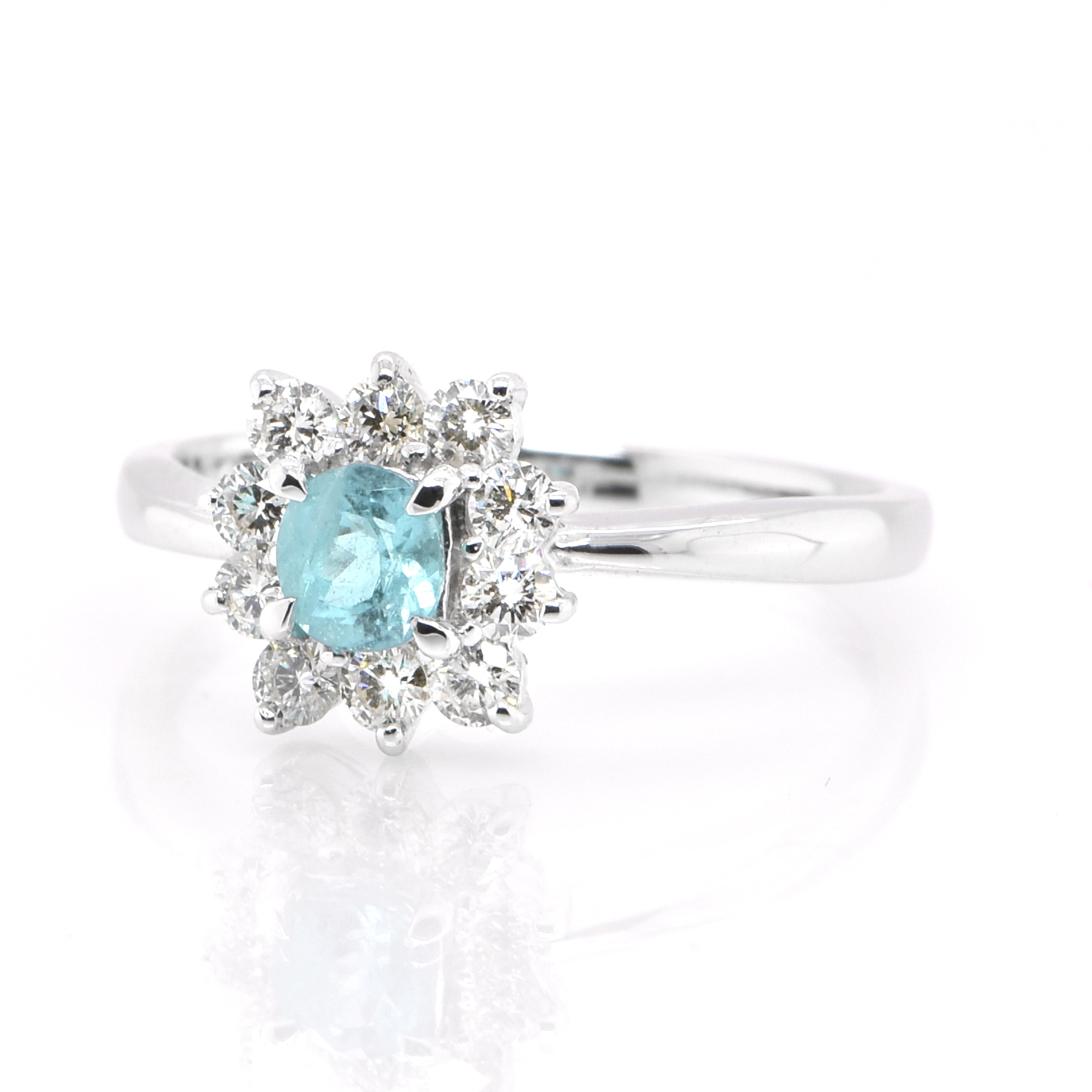 A beautiful ring featuring a GIA Certified 0.30 Carat Natural Brazilian Paraiba Tourmaline and 0.34 Carats of Diamond Accents set in Platinum. Paraiba Tourmalines were only discovered 30 years ago in the Brazilian state of the same name- Paraiba.