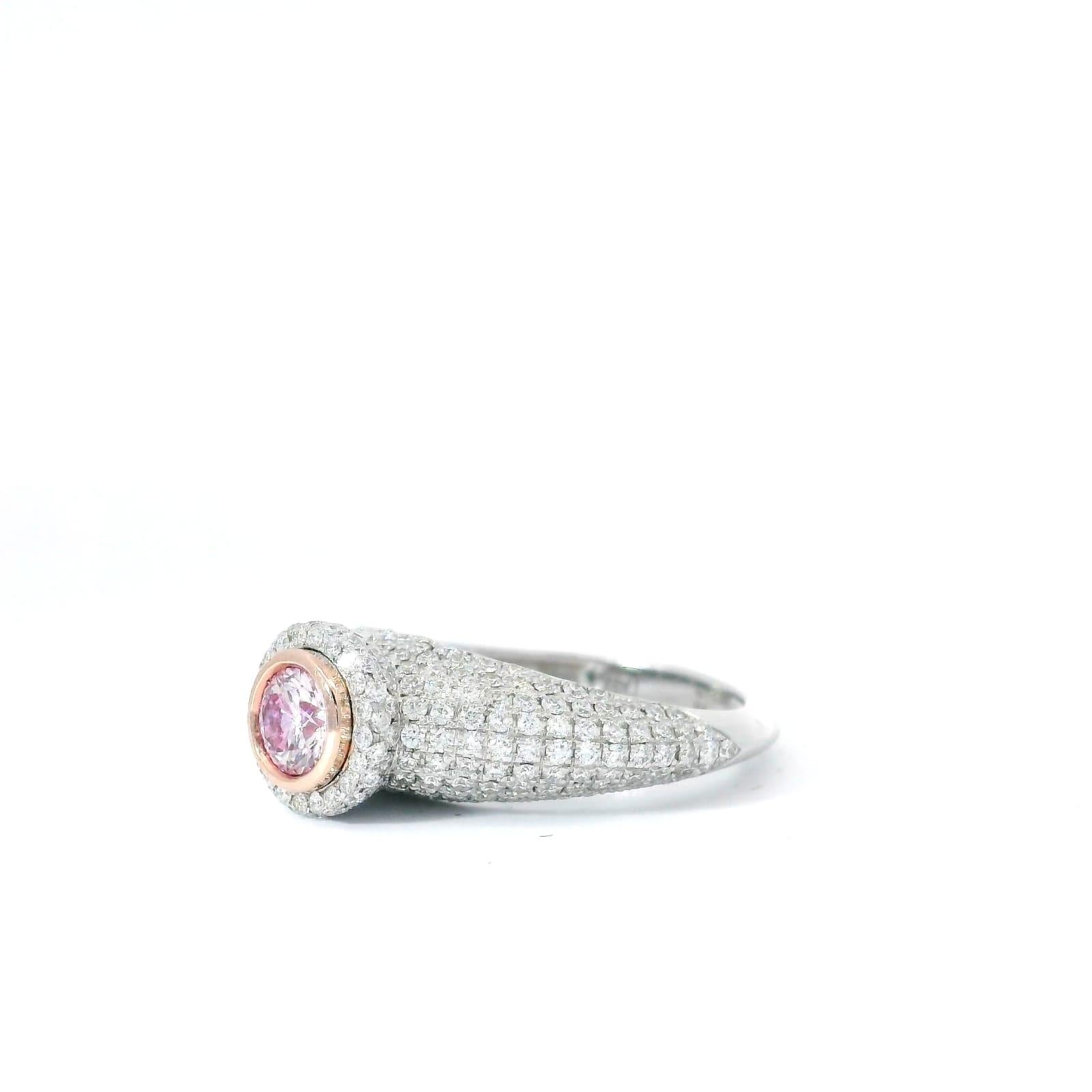  18kt white gold ring with diamonds
  
  Gold colour & karat: White gold 18kt
  Weight: 5.224 grams
  
  Set with-
  Stone type: Diamonds
  Shape: Round
  Carat: 0.31 ct
  Colour: Faint Pink
  Clarity: SI1
  
  Surrounding Stones: Diamonds
 1) White