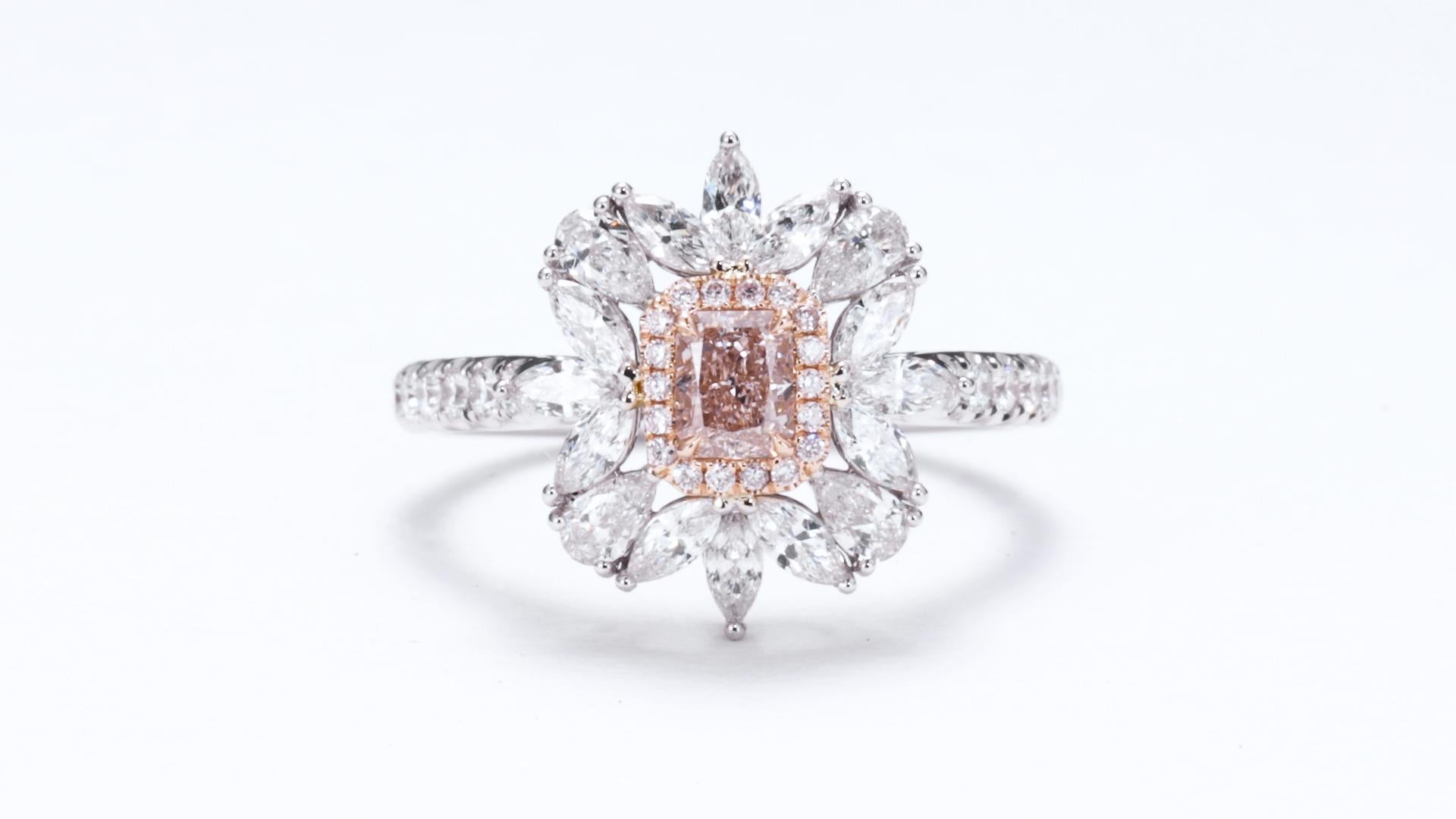 Diamond Weight and Shape: This exquisite ring features a stunning 0.37ct Natural Fancy Light Orangy Pink diamond, cut into a radiant shape. The radiant cut combines the brilliance of a round diamond with the elegance of an emerald cut, resulting in