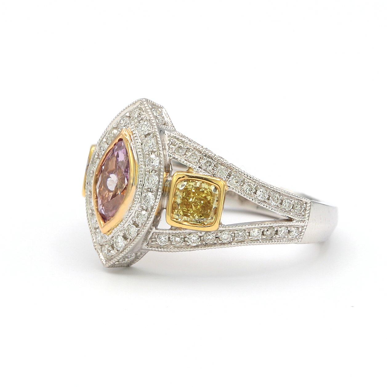 This ring features a 0.40ct Marquee shape Fancy Intense Purple Pink (GIA report no. 16799756) and two Radiant cut Yellow diamonds weighing 0.62ct and 0.52ct. 
The ring is surrounded by white round diamonds.
in 18k White Gold
Ring Size 5.75