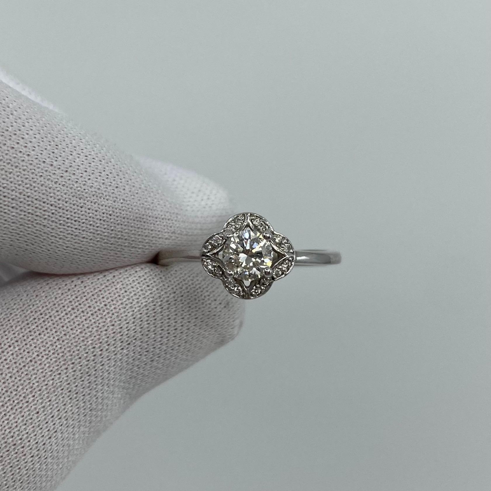 Round White Diamond 18k White Gold Halo Ring.

A beautiful 18 Karat white gold diamond halo ring with pave-set diamonds around the centre stone.
0.40 Carat centre diamond. GIA Certified with VS2 clarity and F colour, also has a very good round