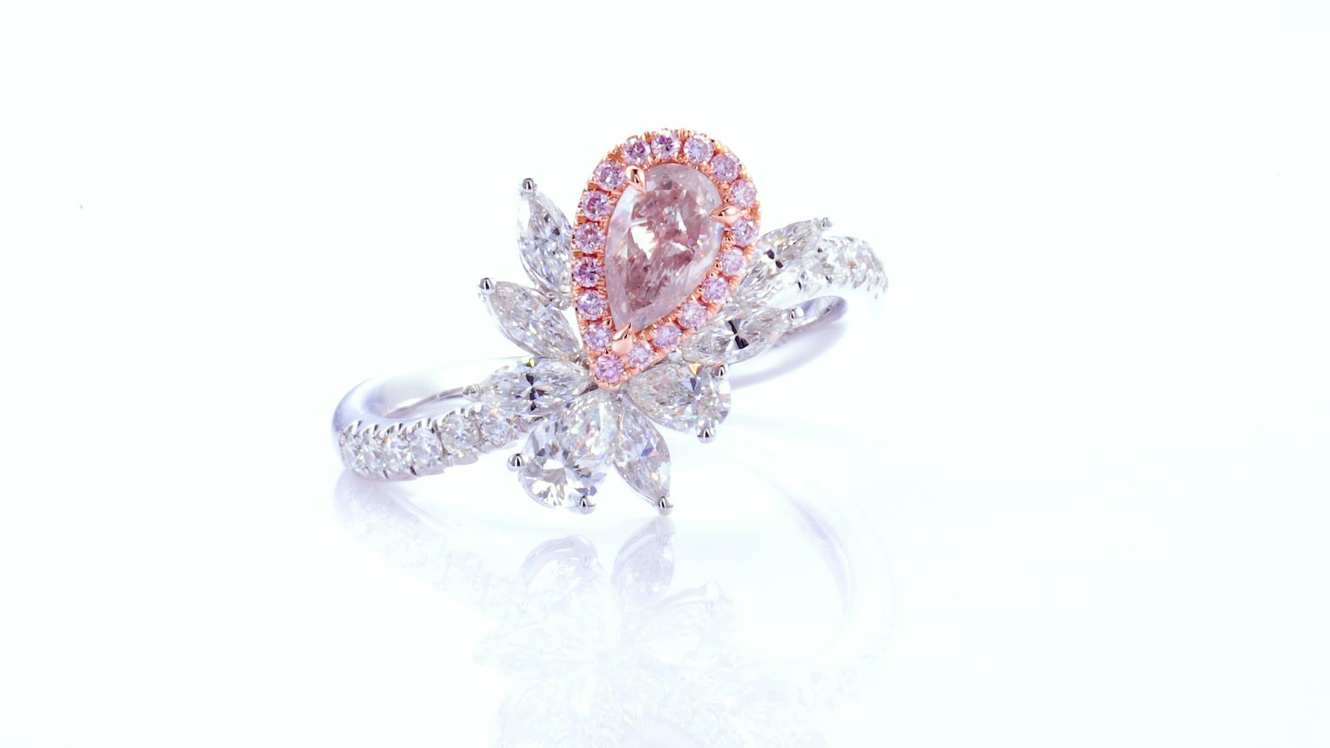 0.40ct Pear shaped natural fancy light pink GIA Certified diamond mounted on 18kt gold with small natural pink and white diamonds. 

A stunning and elegant piece, this fancy light pink pear-studded diamond ring is a true masterpiece. Crafted from