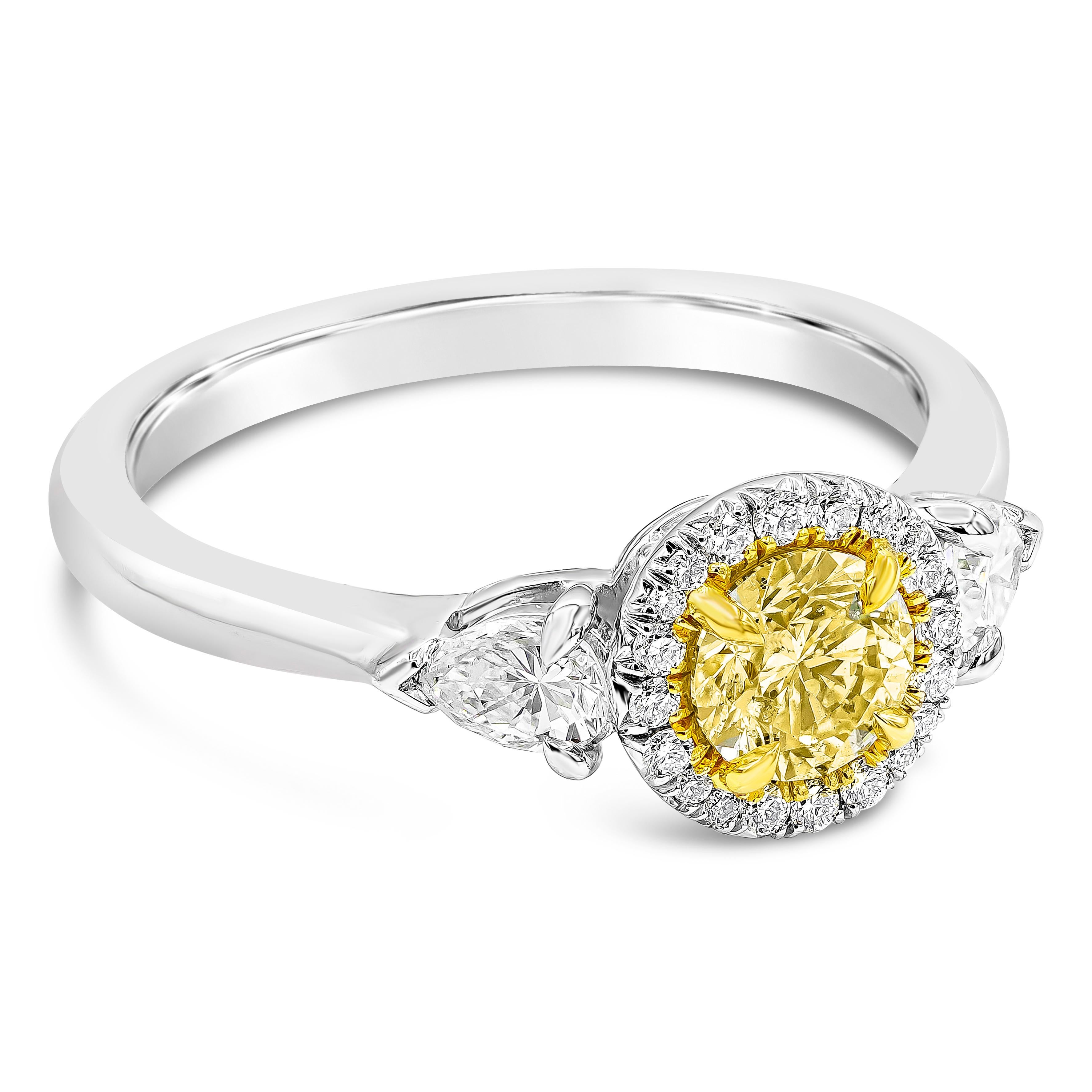 A beautiful engagement ring style, showcasing a 0.50 carat round brilliant cut diamond certified by GIA as Fancy Light Yellowish Green color, set on platinum. The center diamond is surrounded by round brilliant diamonds, flanked by a pear shape