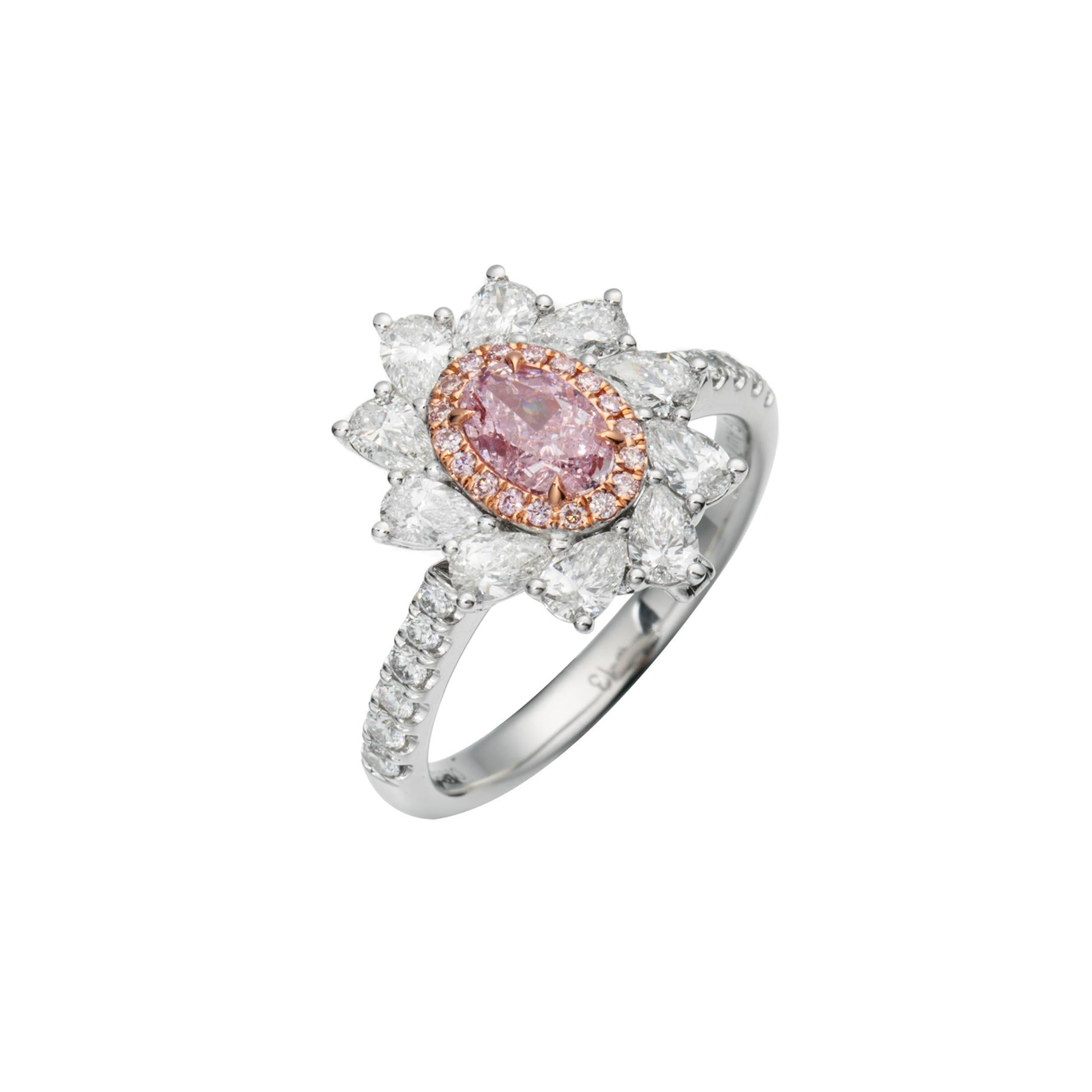 Prepare to be entranced by a symphony of colors and brilliance – the GIA Certified 0.50 carat Natural Fancy Light Purplish Pink Oval Shape Diamond Ring. Set upon a radiant 18kt gold band, this exquisite piece is a true marvel that captures the
