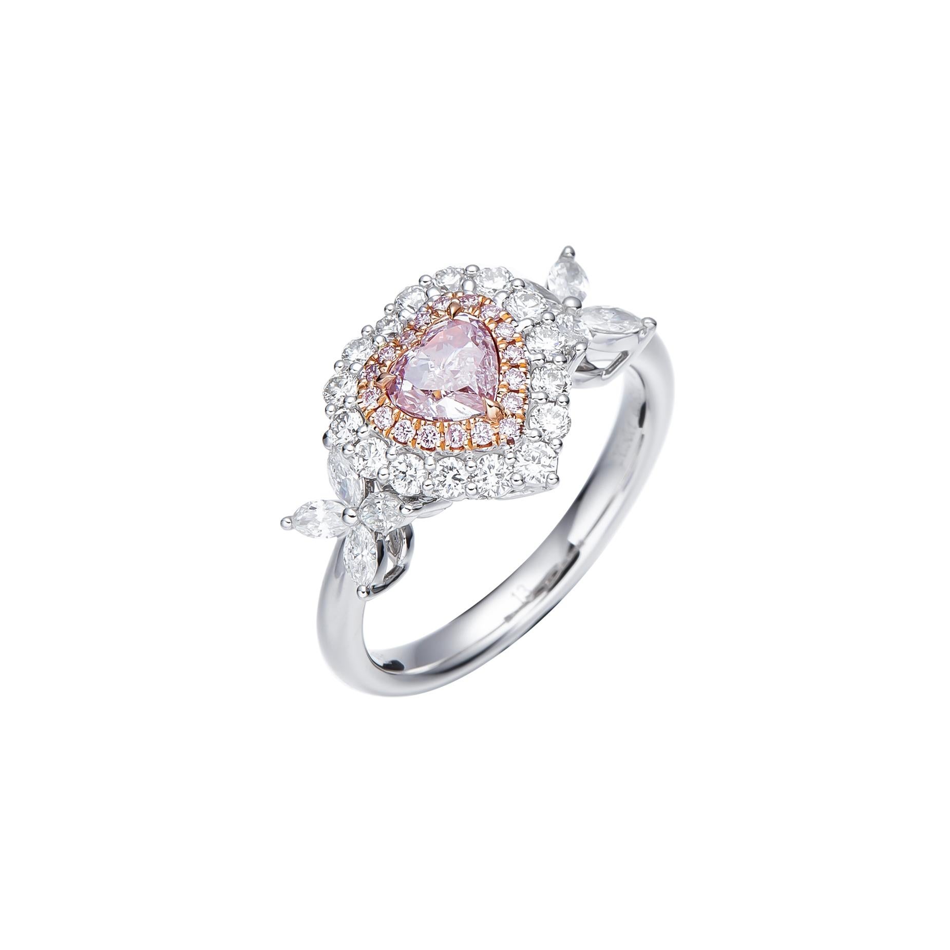 Prepare to be captivated by a dazzling display of romance and elegance – the GIA Certified 0.50 carat Natural Light Pink Heart Shape Diamond Solitaire Ring. Set upon a luminous 18kt gold band, this exquisite piece is a true masterpiece that