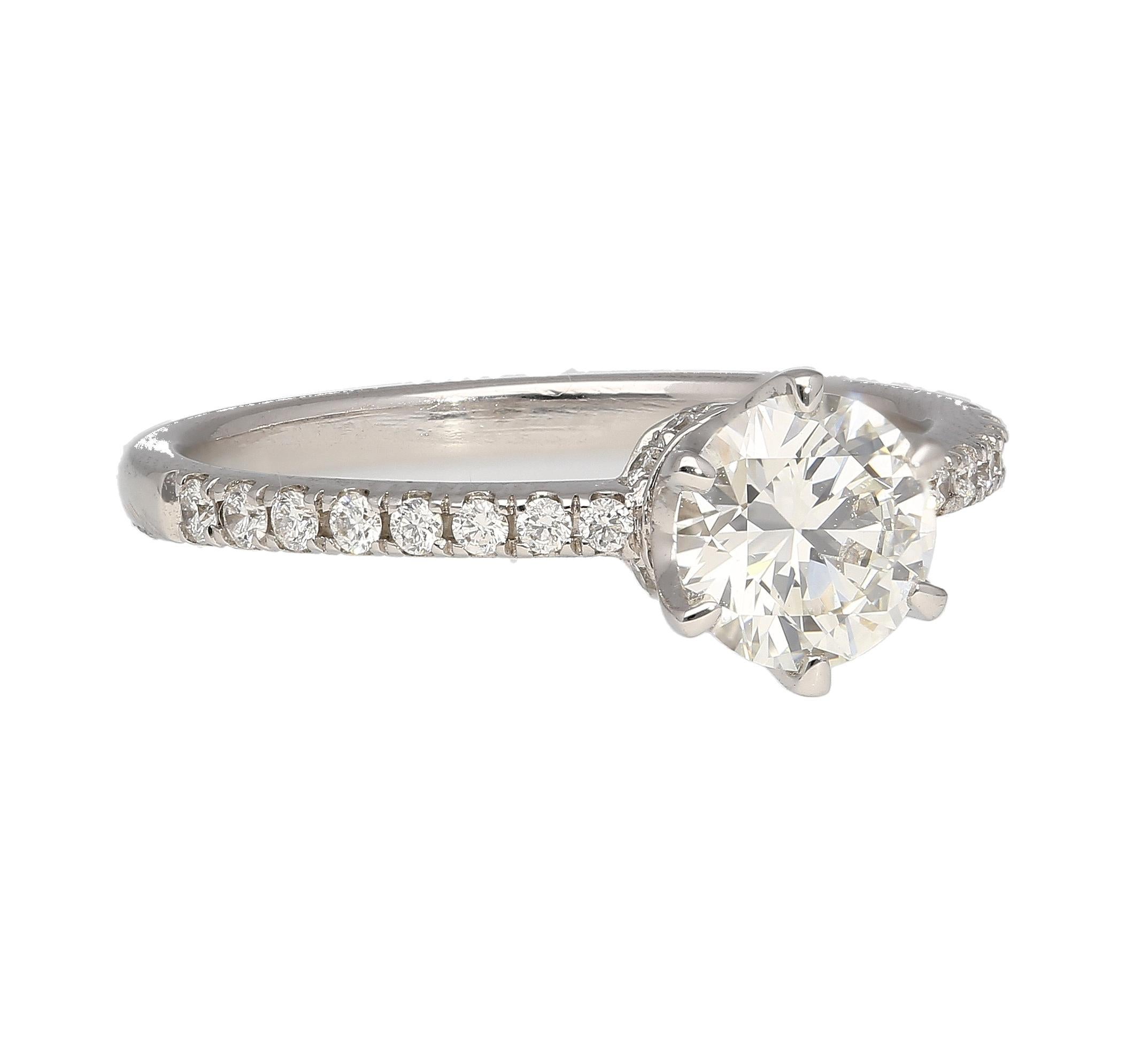 GIA Certified 0.51 Carat Round Cut Diamond Engagement Ring in 18K White Gold. Set in 18k solid white gold with a hidden halo and round cut pave set diamond side stones on the shank. The center stone is 6-prong set, with a stunning crown style basket