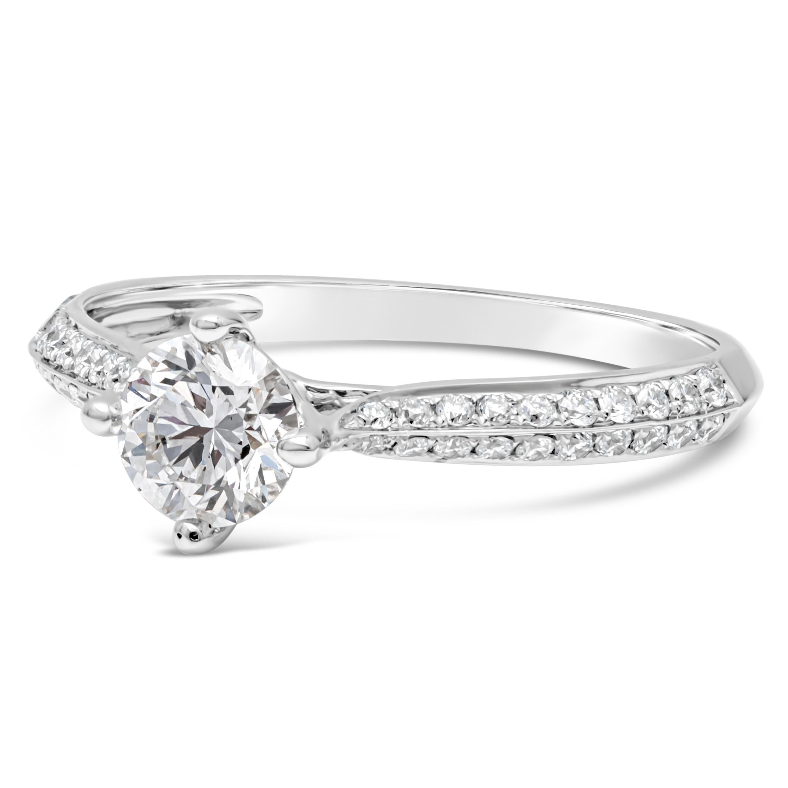 A classic engagement ring showcasing a 0.51 carat round brilliant diamond, GIA certified as F Color and VS2 in clarity. Set in a four prong basket setting. Accented with 0.25 carats total pave-set round diamonds half way around the band. Finely made
