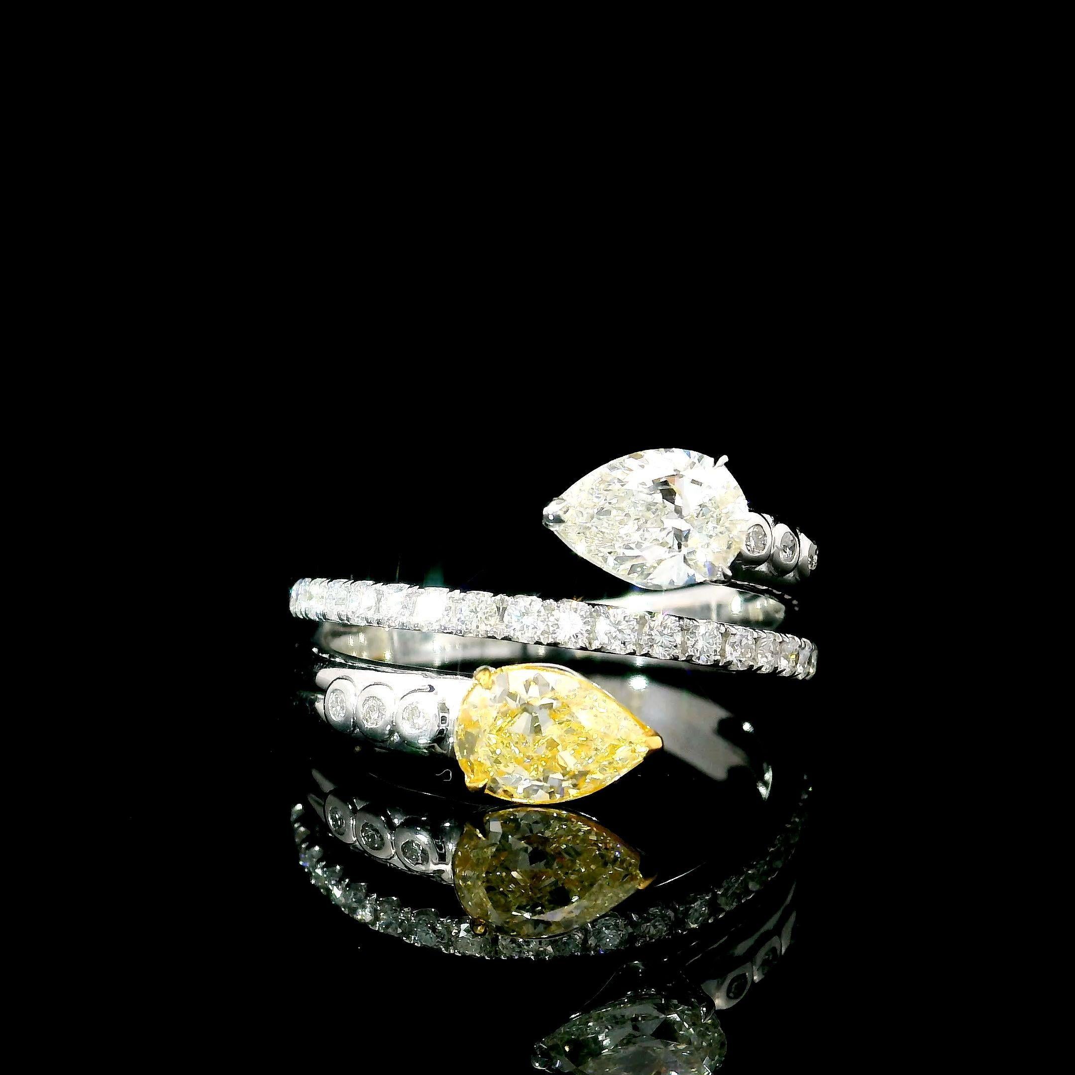 18kt white gold ring with diamonds
  
  Gold colour & karat: White gold 18kt
  Weight: 5.61 grams
  
  Set with-
  Stone type: Diamonds
  Shape: Pear
  Carat: 0.59 / 0.56
  Colour: Fancy Light Yellow / G Colour
  Clarity: VVS1 / VS1
  
  Surrounding