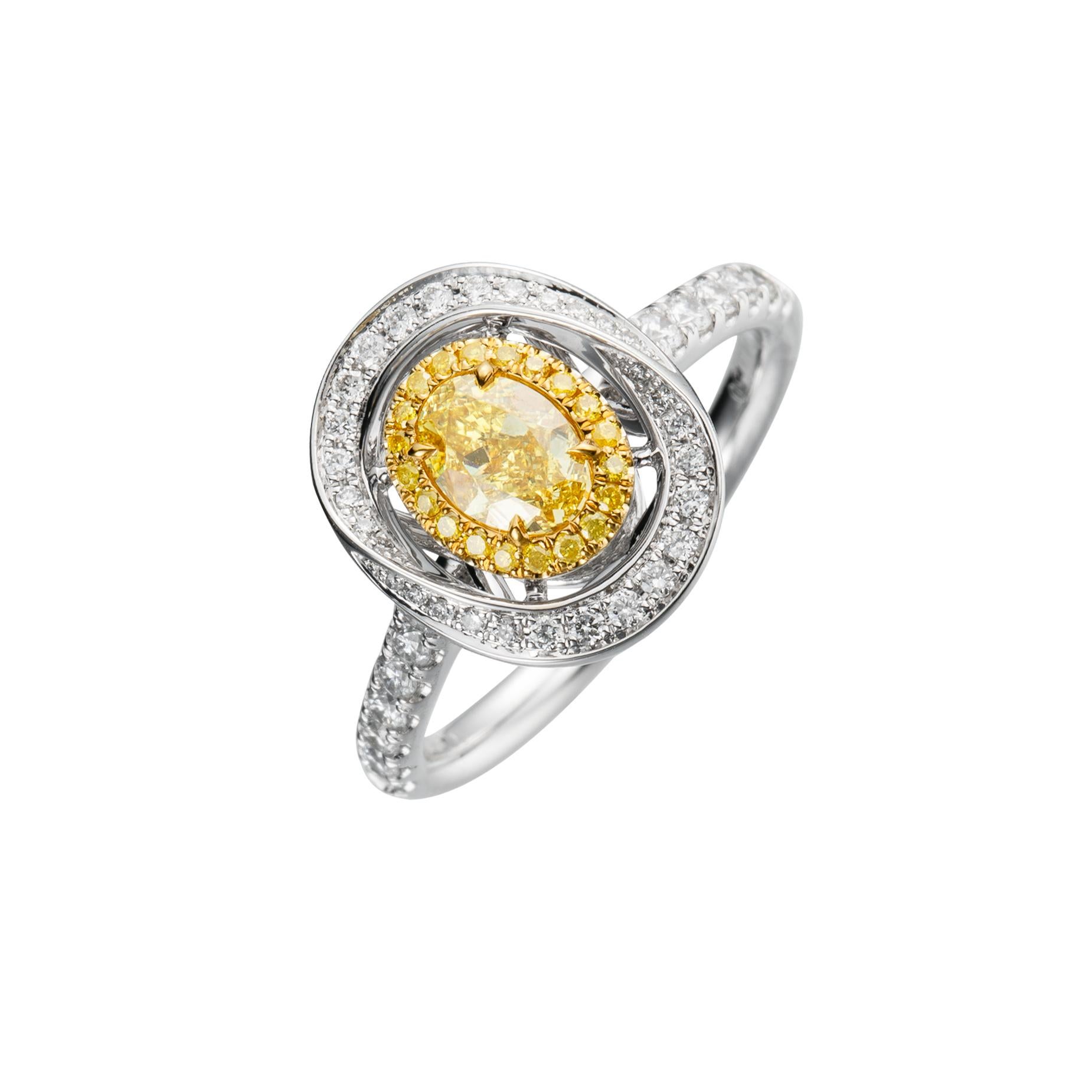 Contemporary GIA Certified, 0.59 Natural Fancy Intense Yellow Oval Shaped Diamond Ring 18KT. For Sale