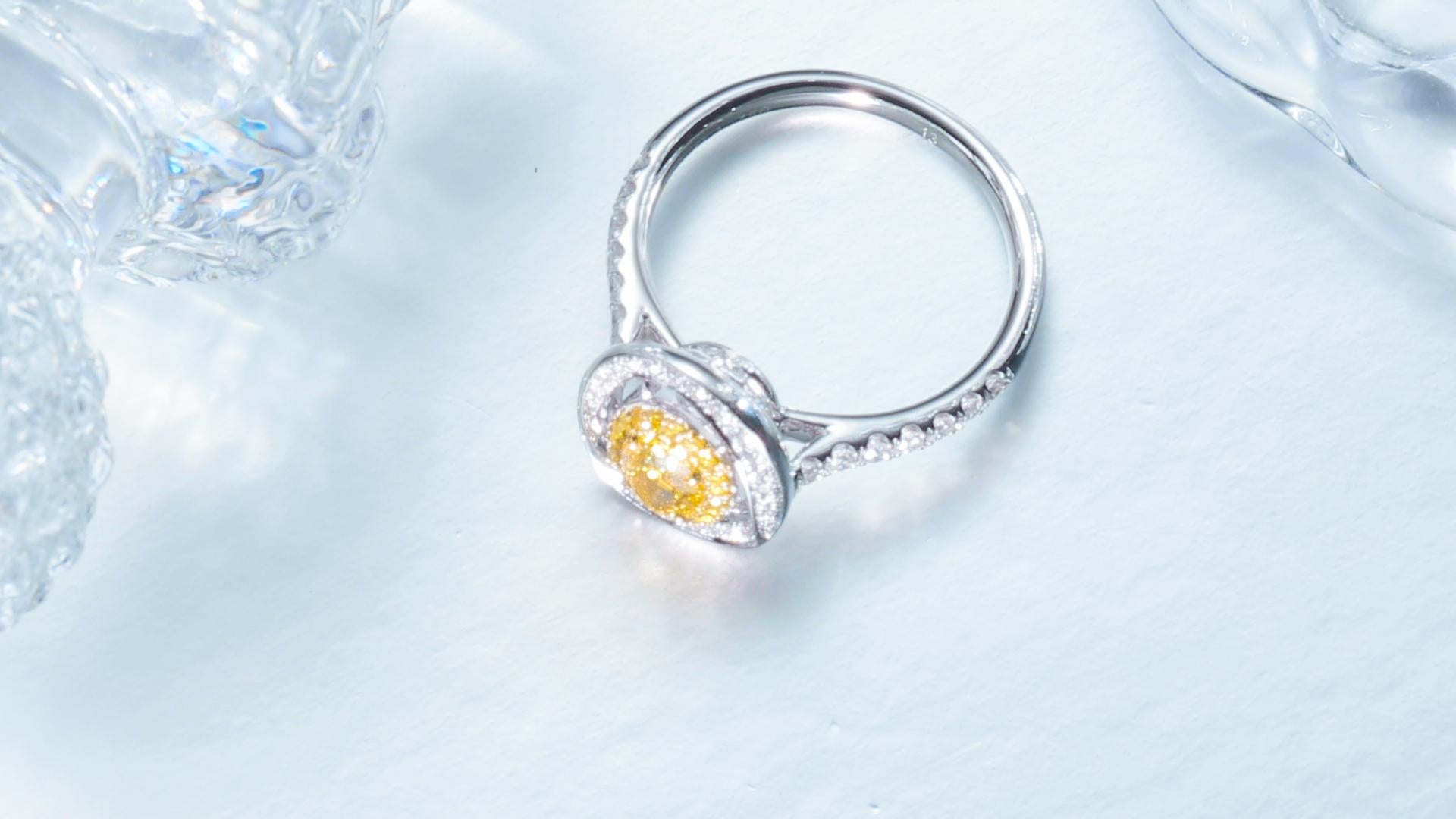 GIA Certified, 0.59 Natural Fancy Intense Yellow Oval Shaped Diamond Ring 18KT. For Sale 1