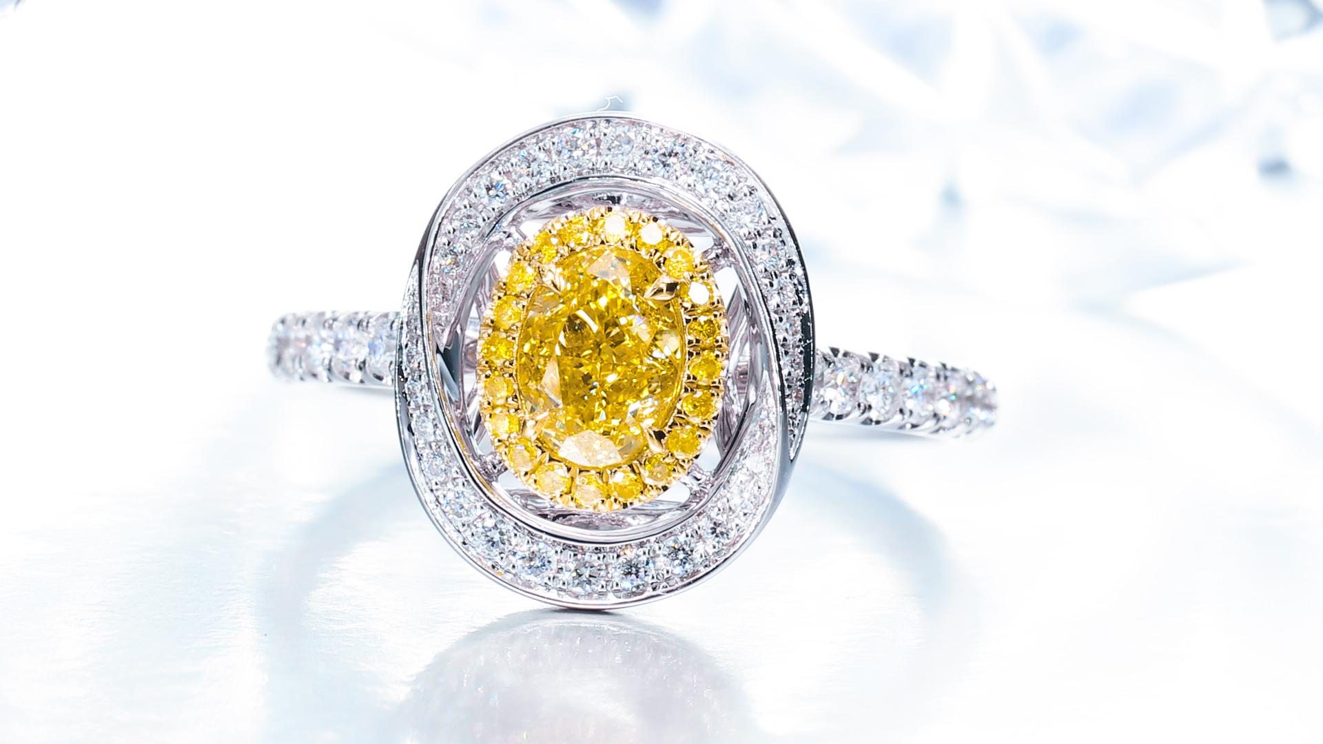 GIA Certified, 0.59 Natural Fancy Intense Yellow Oval Shaped Diamond Ring 18KT. For Sale 2