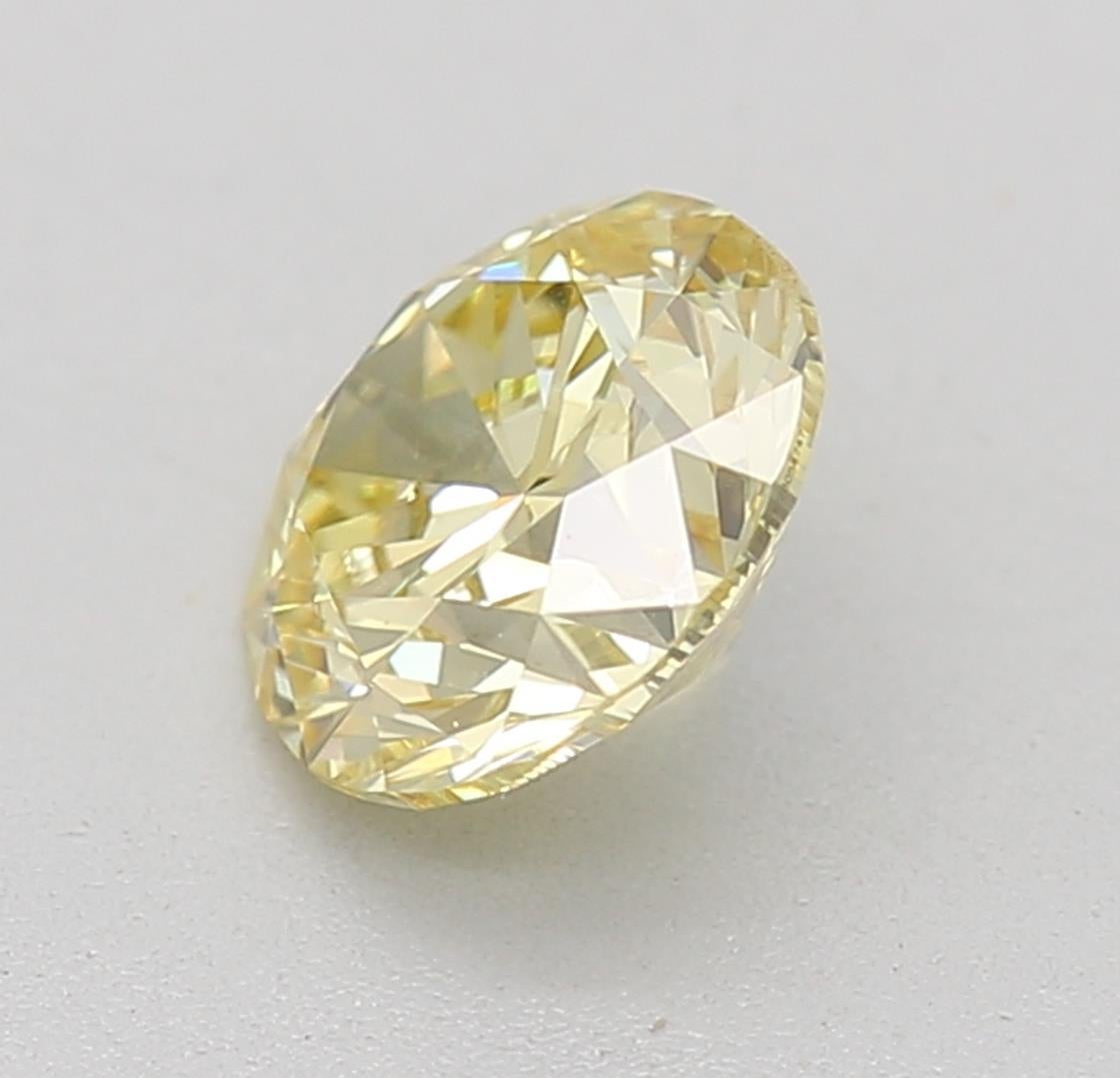 Round Cut GIA Certified 0.60 Carat Fancy Yellow SI1 Clarity Diamond For Sale