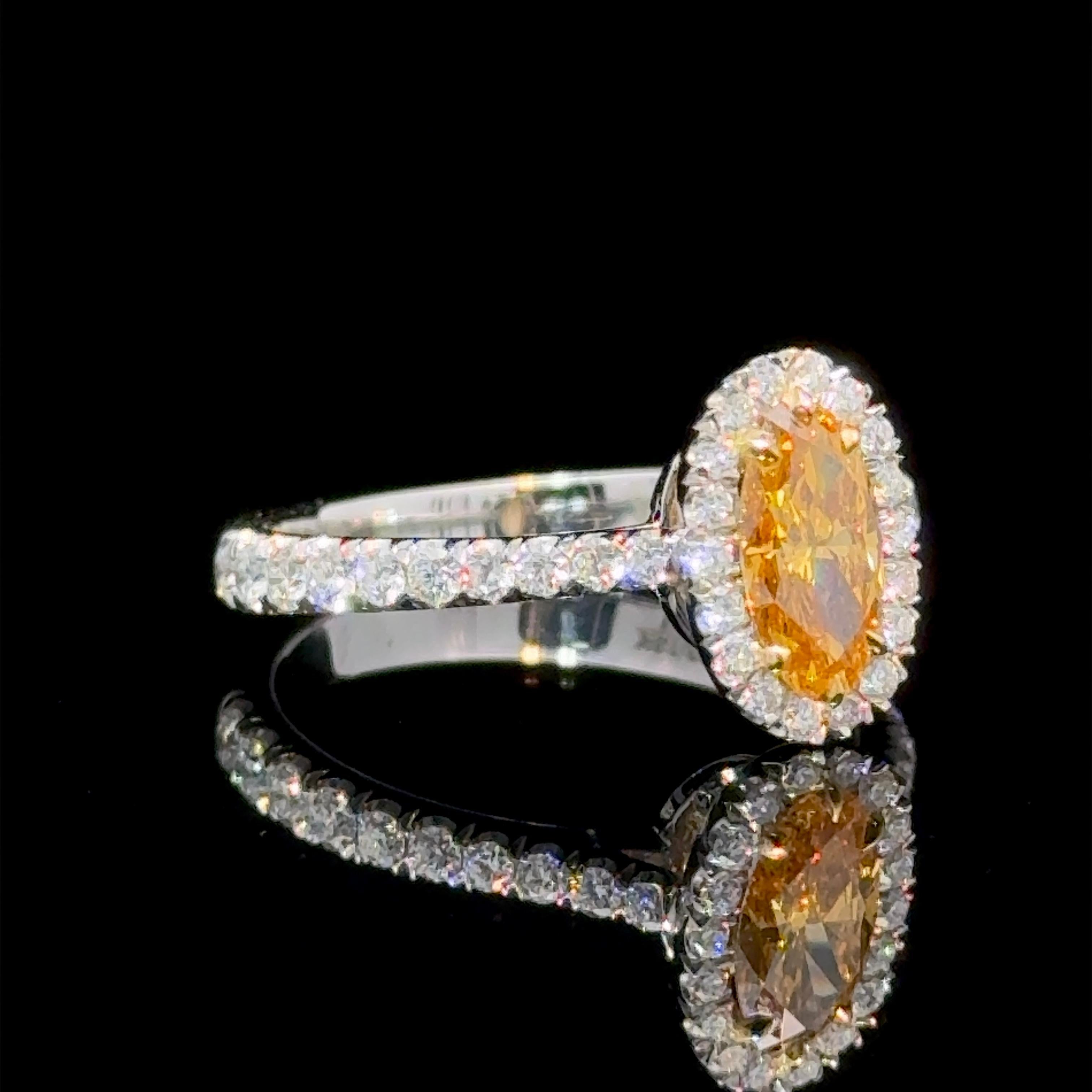 A GIA Certified 0.62 Carat Natural Vivid Orange Diamond Halo Ring
Cut and Natural Color came together to produce a stunning Orange Hue
Center stone is Graded by the GIA as Fancy Vivid Yellow-Orange. SI2 Clarity.
The Cut on Center Elongated Oval Cut,