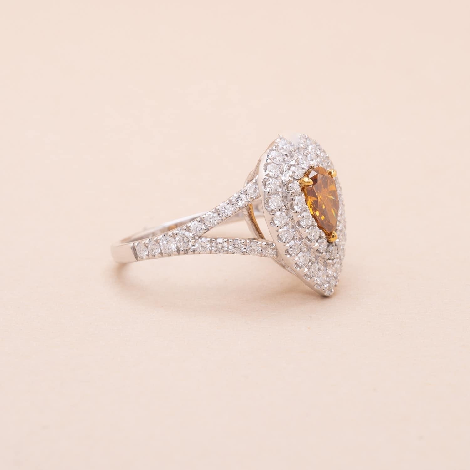 18K white gold 0.62 carat ?Natural Fancy Yellowish Orange pear-cut diamond and 1.25 carat brillant-cut diamonds drop-shaped ring 
Certified GIA report n°5181790757
Ring size (adjustable on demand) : 53 FR
Gross weight : 5.01g 

Original and yet