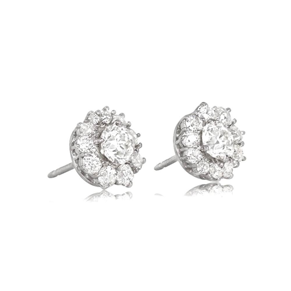 Crafted in platinum, these exquisite diamond cluster earrings showcase the timeless elegance of the Edwardian era. Each earring features a GIA-certified old European cut diamond, weighing 0.63 and 0.65 carats, respectively. The 0.63-carat diamond