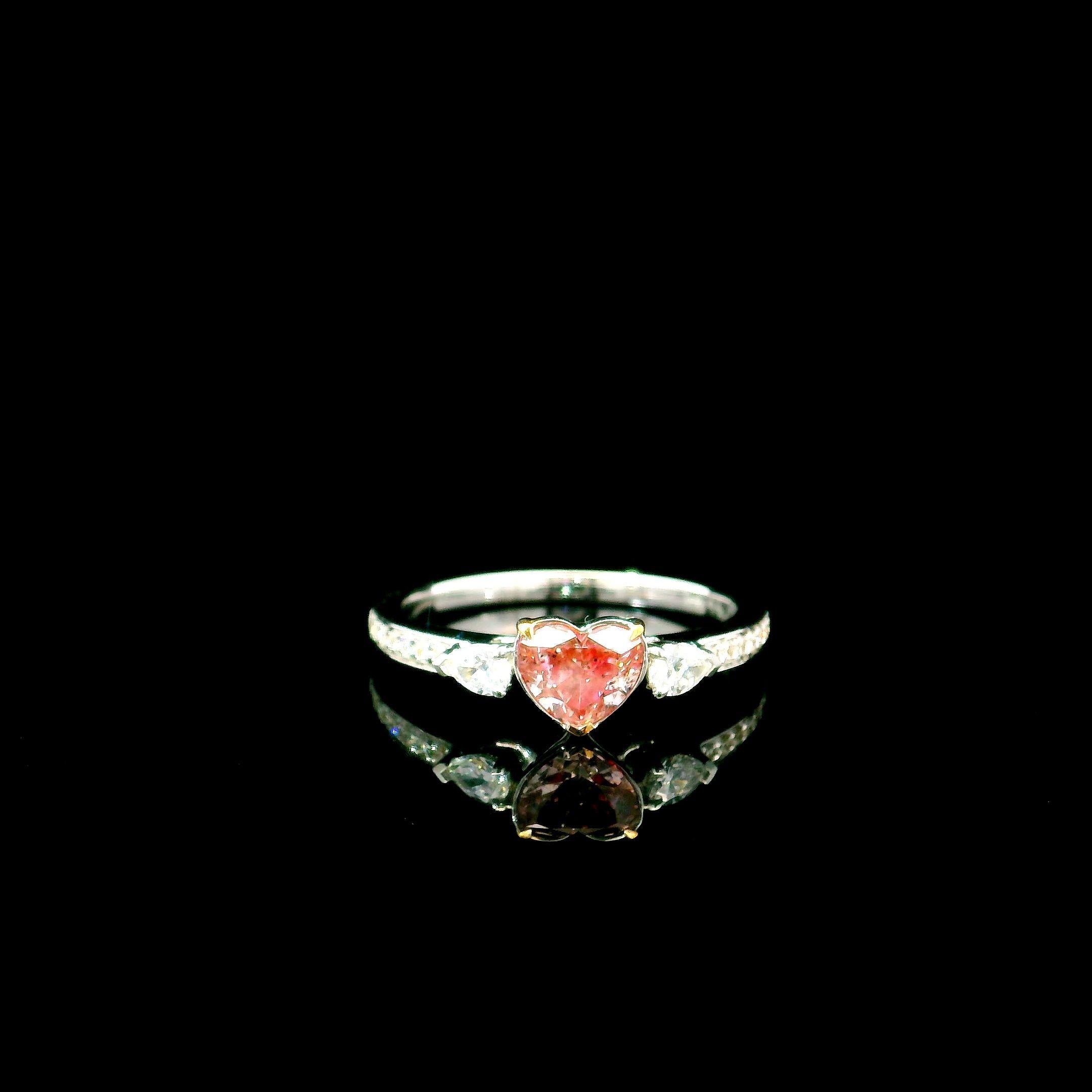 18kt white gold ring with diamonds
  
  Gold colour & karat: White gold 18kt
  Weight: 2.82 grams
  
  Set with-
  Stone type: Diamonds
  Shape: Heart
  Carat: 0.64
  Colour: Fancy pink
  
  Surrounding Stones: Diamonds
 1) White Diamonds
  Carat