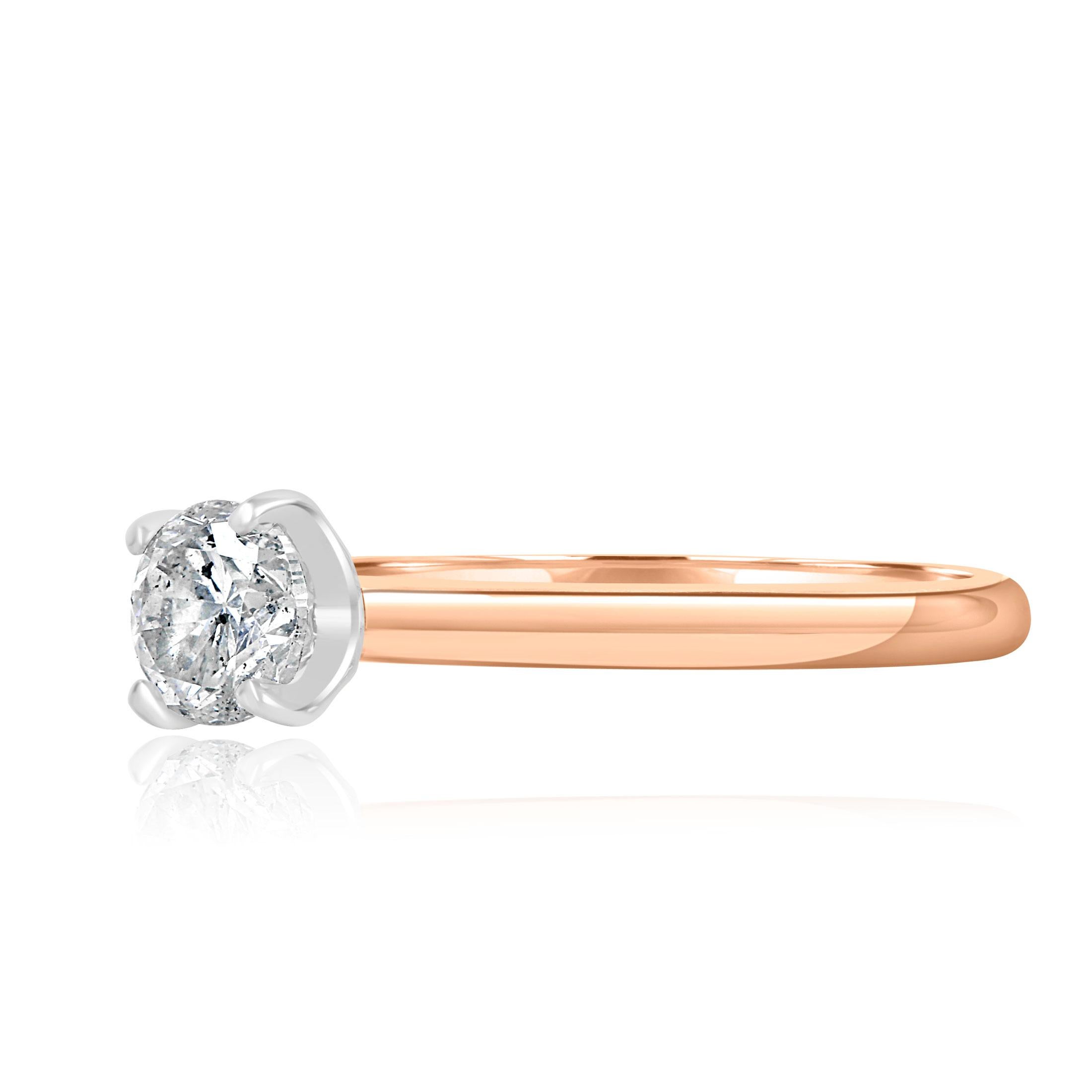 This elegant minimalist engagement ring features a 0.69-carat GIA-certified round brilliant-cut diamond with measurements of 5.55 - 5.59 x 3.56 mm. The diamond boasts a D color and I1 clarity, as detailed in GIA report number 2165365727. Securely
