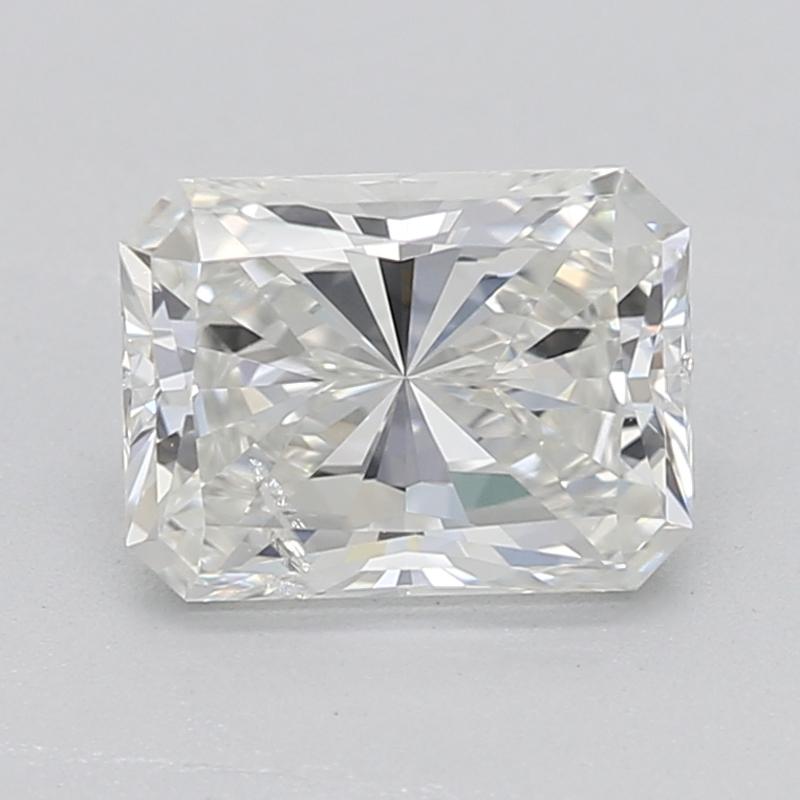 Handcrafted in New York, this exquisite diamond ring showcases a captivating radiant H SI2 0.7 center stone, brilliantly set in a classic four-prong setting that elevates its radiant beauty. The ring is elegantly adorned with shimmering tapered