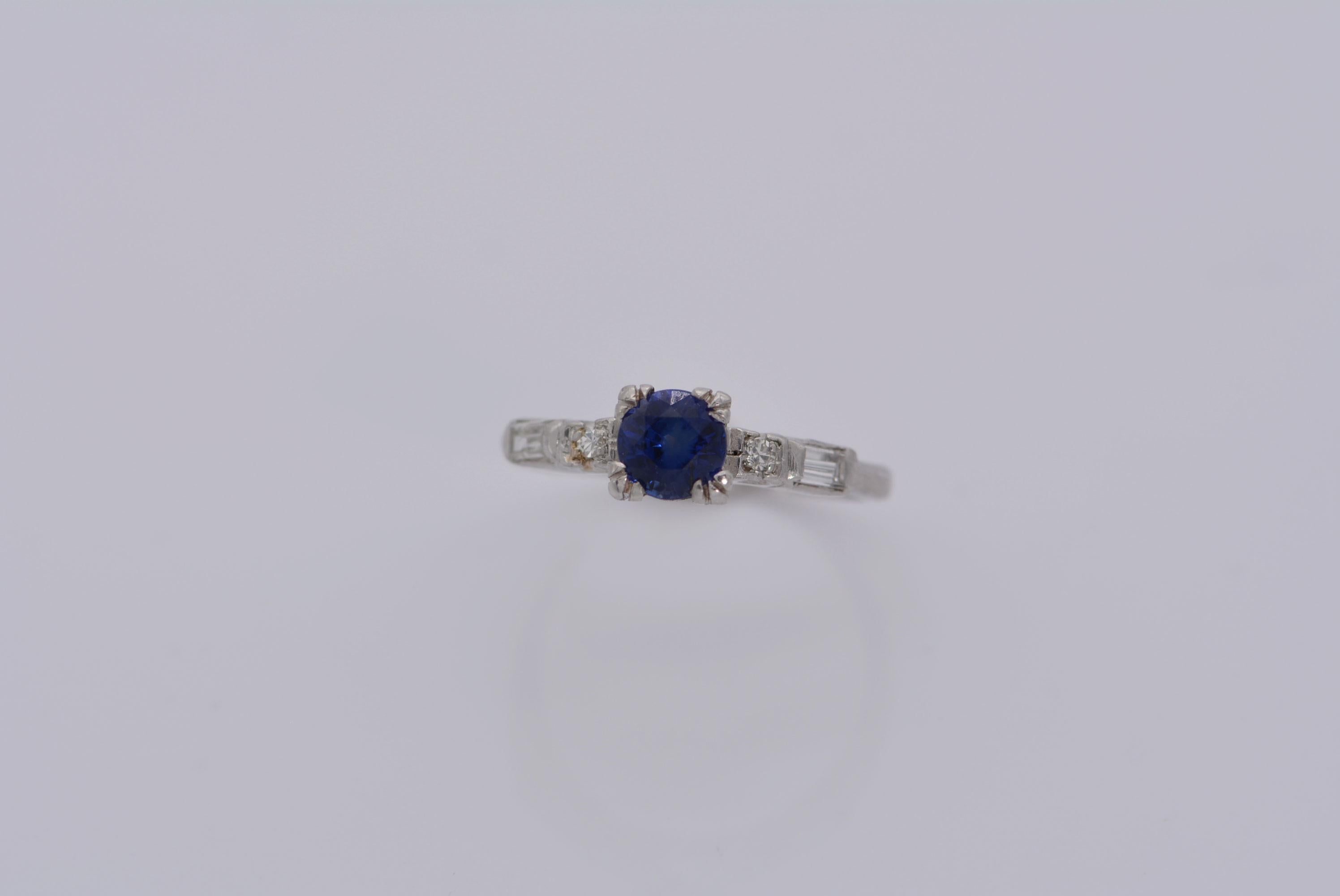 A classic midcentury design in platinum that continues to be produced today!
This ring has a stunning blue sapphire as its main stone, that weighs 0.70ct, which has a GIA origin report stating that it's of Madagascar origin and has had heat