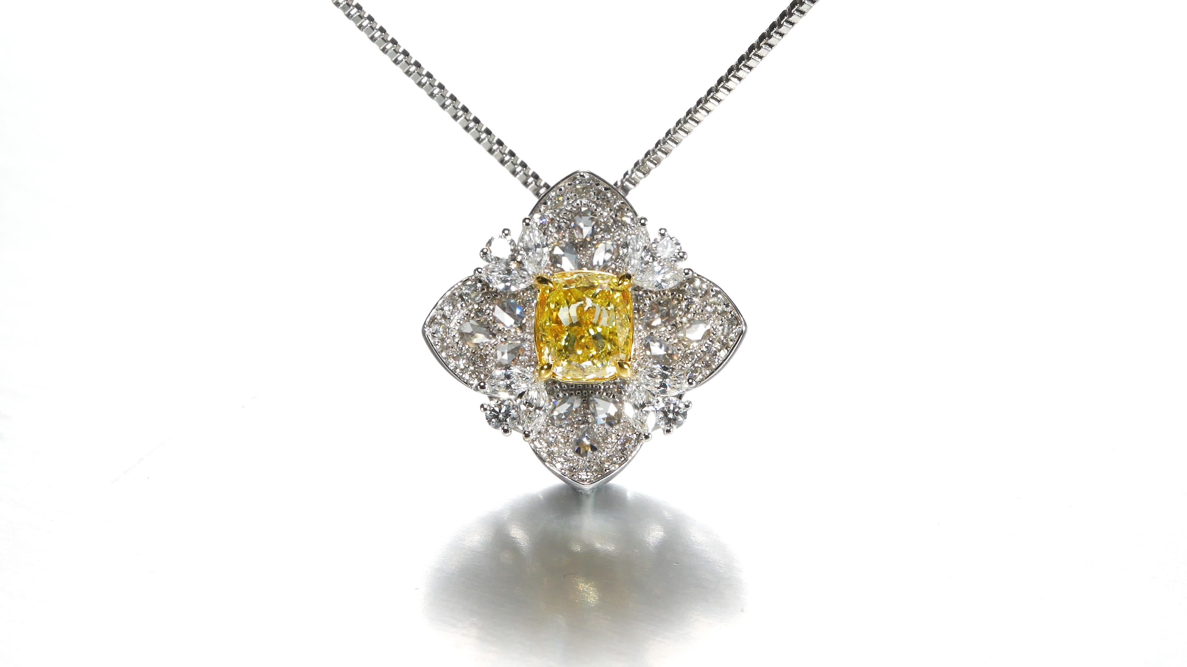 GIA Certified 0.70ct Natural Fancy Intense Yellow Cushion Shape Diamond, a radiant gem that takes center stage in this extraordinary creation. Graced by the esteemed certification of the Gemological Institute of America (GIA), this diamond is a