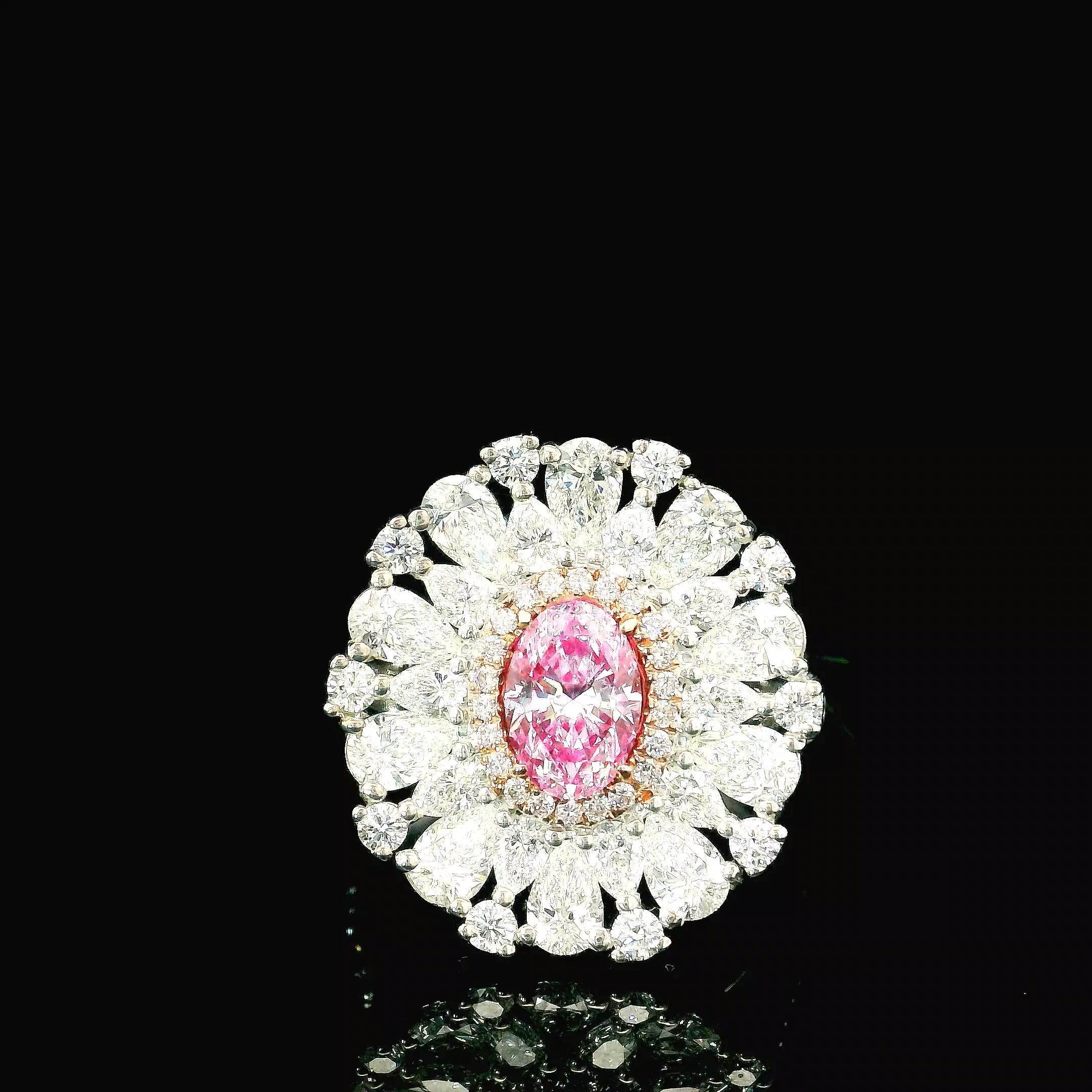18kt white gold ring with diamonds
  
  Gold colour & karat: White gold 18kt
  Weight: 7.67 grams
  
  Set with-
  Stone type: Diamonds
  Shape: Oval
  Carat: 0.71 ct
  Colour: Faint Pinkish Brown
  Clarity: VS2
  
  Surrounding Stones: Diamonds
 1)