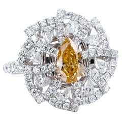 GIA Certified. 0.75ct Pear Shaped Natural Fancy Vivid Orangy Yellow Diamond Ring
