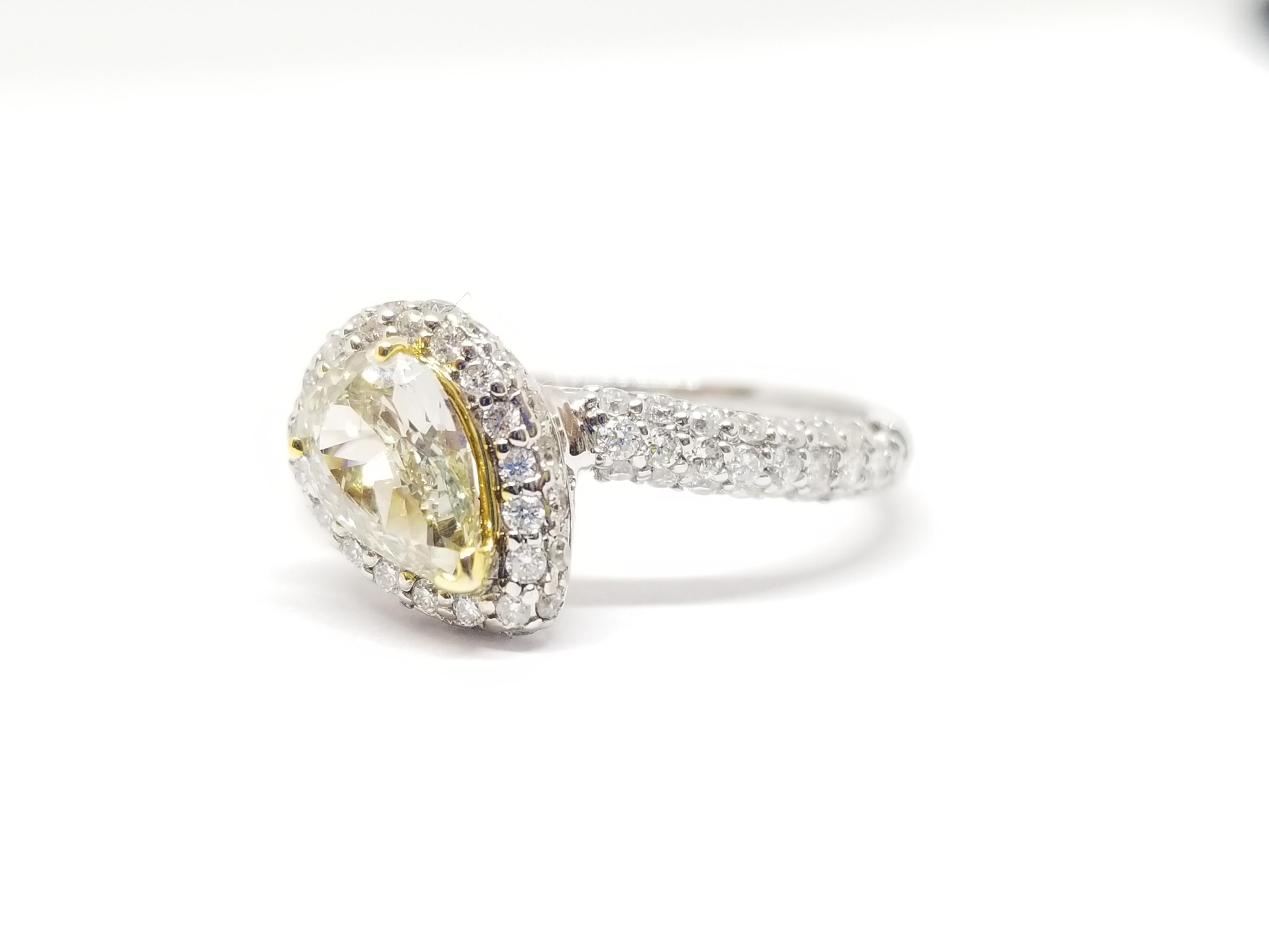 Fancy light brownish greenish yellow Pear Shape natural diamond weighing 0.76 carats GIA. surrounded by paved white diamonds in the halo setting. Its transparency and luster are excellent. set on 18K white gold, this pear ring is the ultimate gift