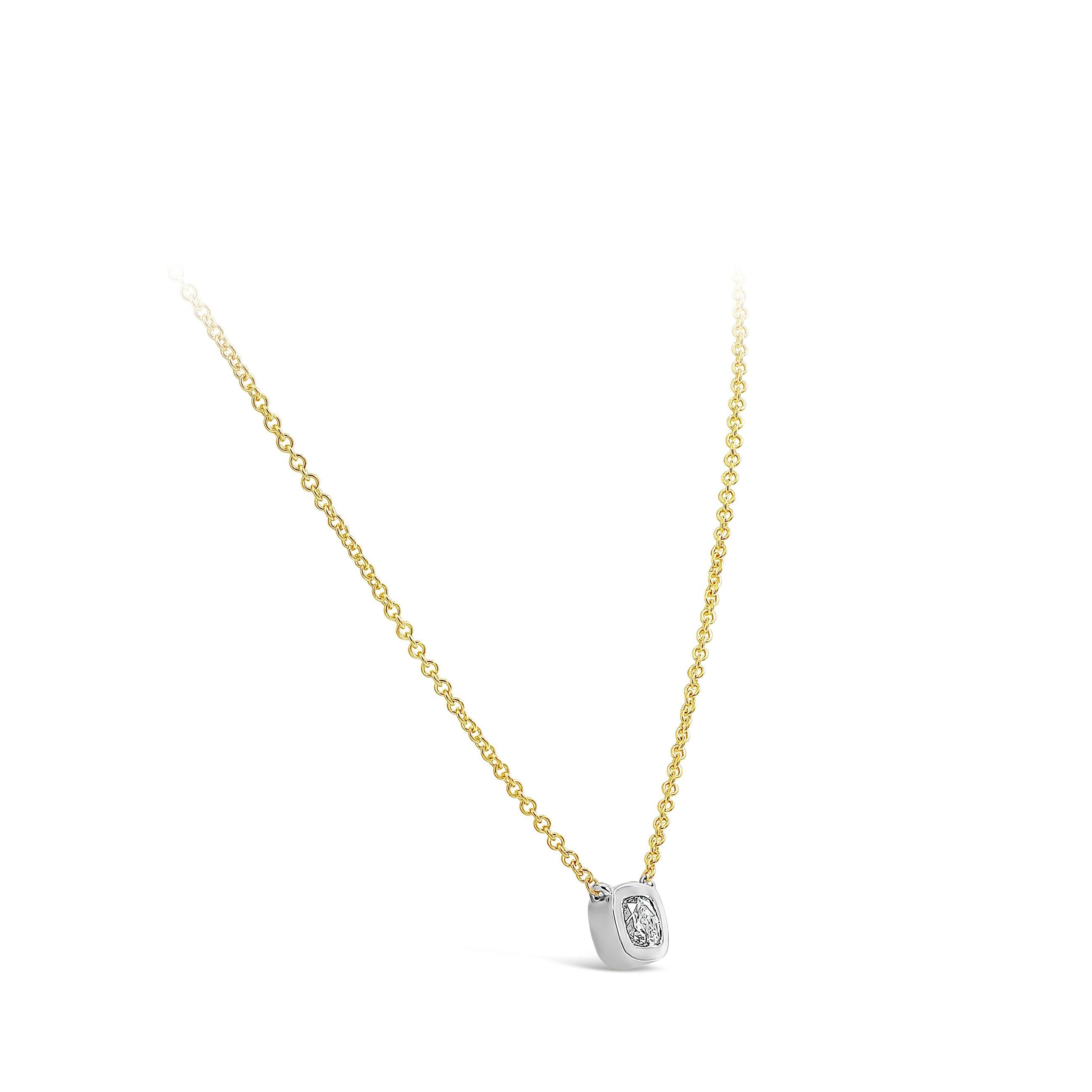 A simple pendant necklace, showcasing a 0.77 carat cushion cut diamond certified by GIA as E color and SI2 clarity, bezel-set in a 14K white gold mounting. Suspended on a 14K yellow gold chain, 16 inches in length. Perfect for everyday wear. 

Roman