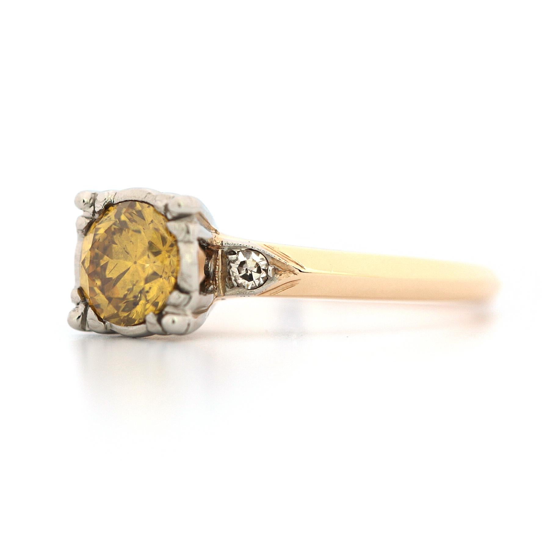 This 14 karat vintage engagement ring is set with a 0.77 carat Round Fancy Deep Orangy yellow diamond with a clarity of SI2 (GIA certificate no. 5172419713), and features two side round old cut diamonds weighing approximately 0.06 carats.
Ring Size