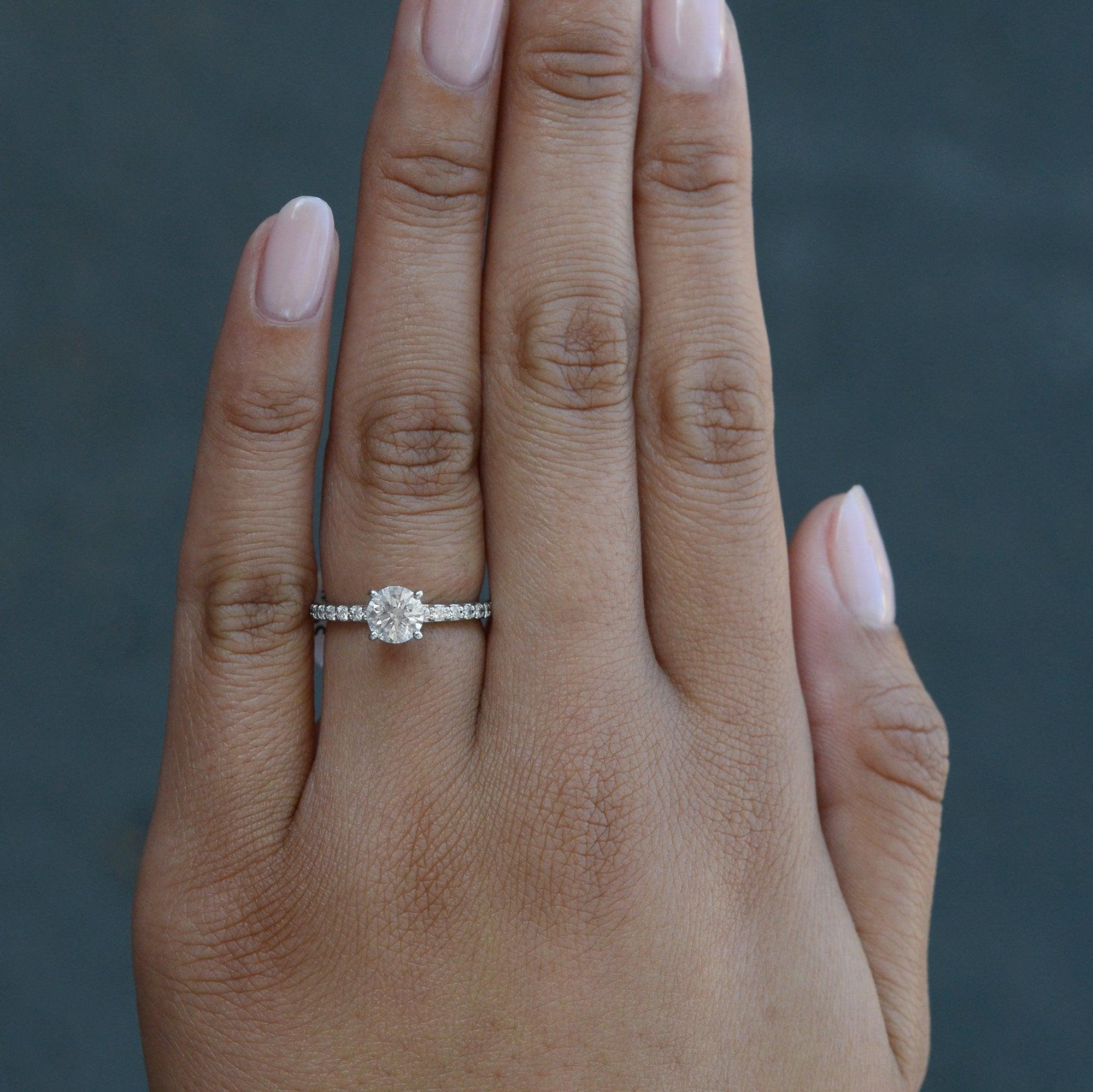 This certified solitaire diamond engagement ring features a 0.80 carat round brilliant diamond, colorless and sparkling with modern brilliance. Certified by GIA, the Gemological Institute of America, as VS1 clarity and (E) colorless noted with a