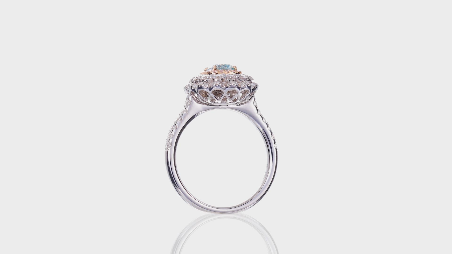 This stunning 18k white gold ring is a true masterpiece, crafted to showcase the beauty of natural diamonds. The centerpiece of this ring is a GIA-certified cushion-cut diamond weighing 0.80 carats, with a captivating light green color and a clarity